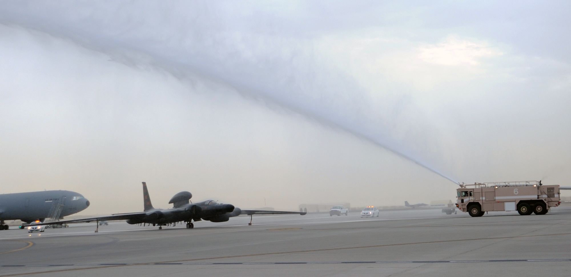 SOUTHWEST ASIA - Lt. Col. Alberto, 380th Expeditionary Operations Group deputy commander, taxis his U-2 under a stream of water from a fire truck April 1, 2012, congratulating him for reaching his 1,000th flight hour in the U-2. He's deployed from Beale Air Force Base, Calif. For security reasons, U-2 pilots can only be identified by their first names. (U.S. Air Force photos/Staff Sgt. J.G. Buzanowski)