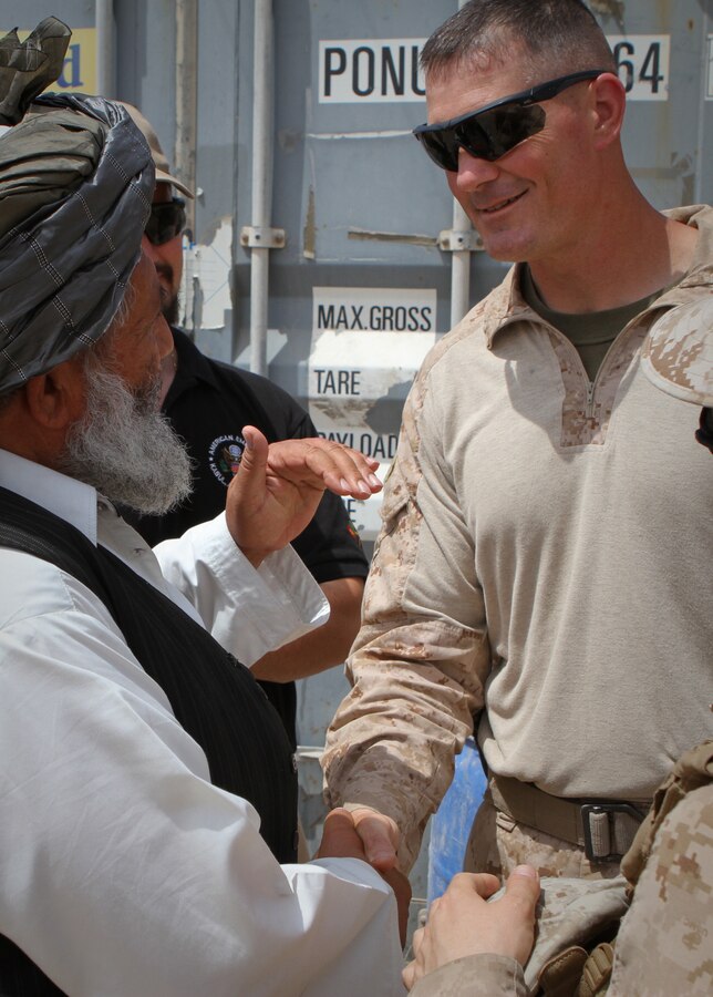 U.S. Marine Lt. Col. Matthew T. Morrissey, the 2nd Battalion, 6th Marine Regiment commanding officer, greets Nawa district governor Abdul Manaf, during a meeting at the district center here, April 7, 2012. Colonel Roger Turner and Sgt. Maj. Alberto Ruiz, the Regimental Combat Team 5 commanding officer and sergeant major, recently stopped at the district center to during a  trip to several combat outposts across Nawa.