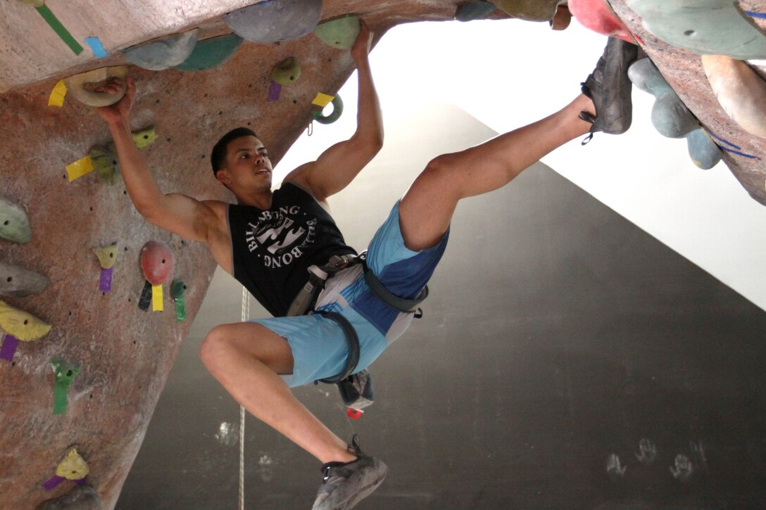 Lance Cpl. Joshua Diaz, tower noncommissioned officer at the Horno pistol range, Marine Corps Base Camp Pendleton, transition from one wall to the another utilizing conveniently placed hand holds while following a preset path marked off with yellow tape, April 24.