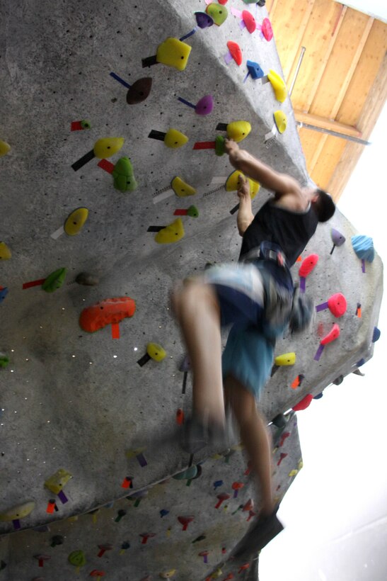 Lance Cpl. Joshua Diaz, tower noncommissioned officer at the Horno pistol range, Marine Corps Base Camp Pendleton, showcases his rock climbing skills while using arms only to climb over a man-made boulder, April 24.