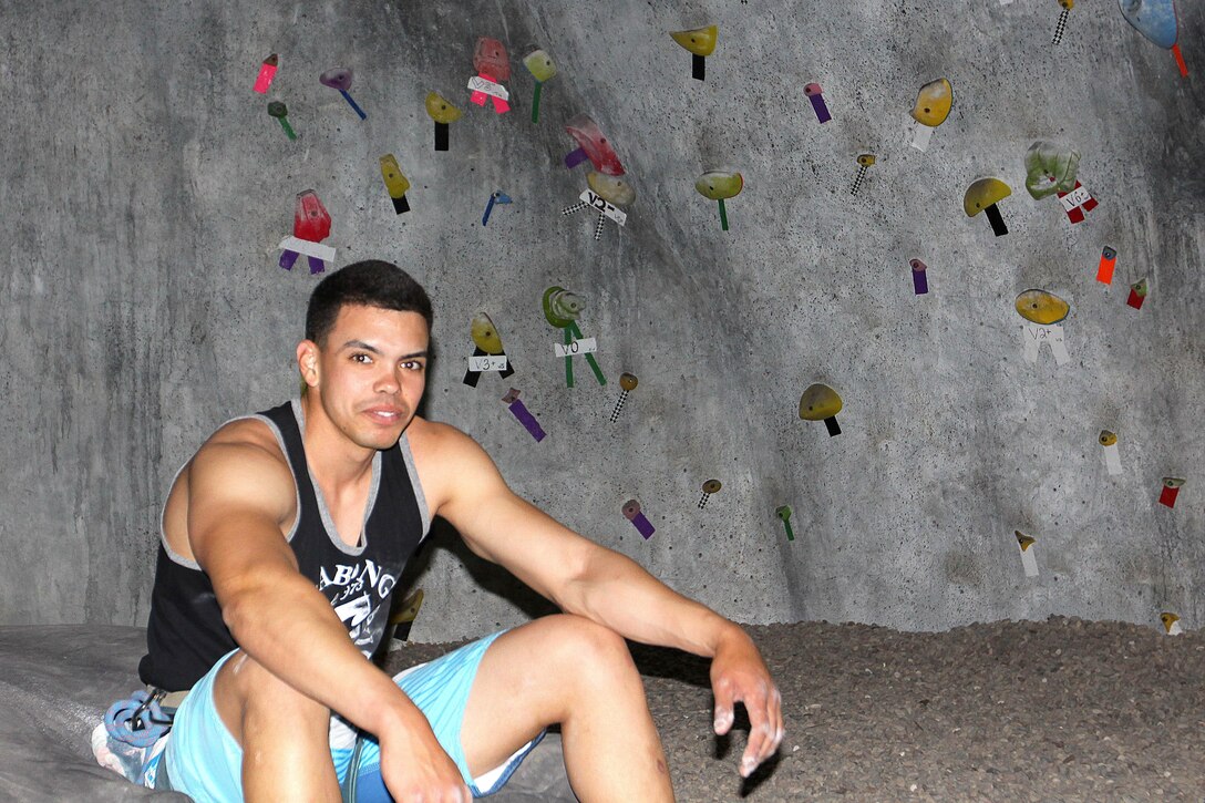 Lance Cpl. Joshua Diaz, tower noncommissioned officer at the Horno pistol range, Marine Corps Base Camp Pendleton, rests after climbing to the top of a man-made boulder, April 24.