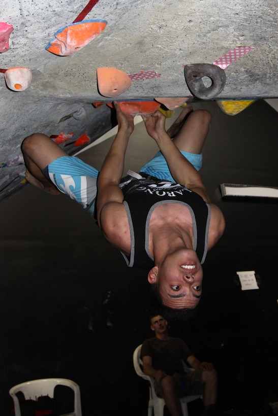 Lance Cpl. Joshua Diaz, tower noncommissioned officer at the Horno pistol range, Marine Corps Base Camp Pendleton, utilizes his fingers and toes as he climbs down, head first, the man-made boulder, April 24.