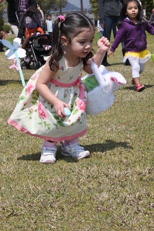 Maritanya J. Jones, 2, looks for Easter eggs during the station Easter egg hunt on the Torii Pines Golf Course April 8. Every group of eggs had one to two golden eggs hidden, and special prizes were awarded to the golden egg finders.