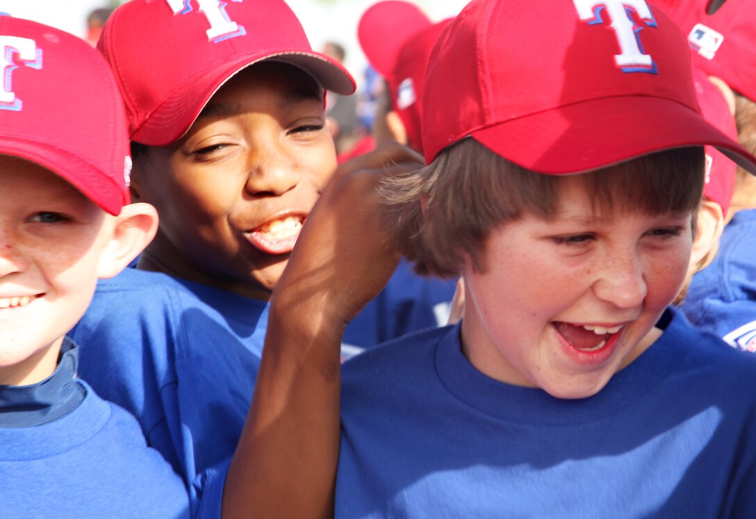 Keshan Rowe, 12, son of Staff Sgt. Amelia M Rowe, career planner, Headquarters Battalion, and Kirby Cooper, 12, son of Sgt. Maj. Scott E. Cooper, battalion sergeant major, HQBN, showed their excitement just before their game started at Luckey Park April 8, 2012.