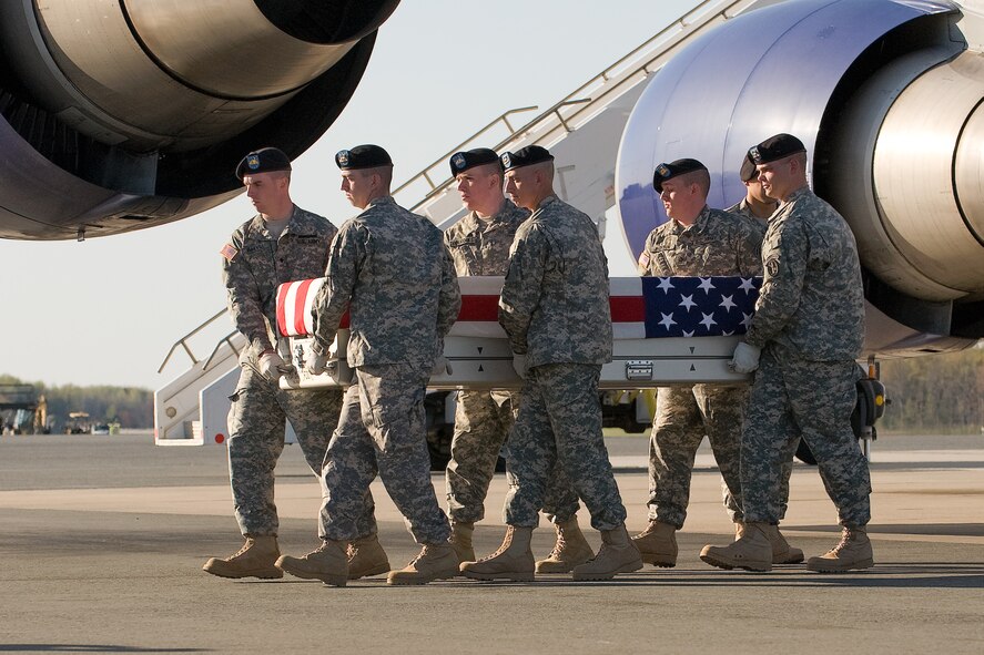 A U.S. Army carry team transfers the remains of Army Sgt. 1st Class Jeffrey J. Rieck, of Columbus, Ohio, at Dover Air Force Base, Del., April 7, 2012. Rieck was assigned to the 1st Battalion, 148th Infantry Regiment, 37th Infantry Brigade Combat Team, Ohio National Guard, Walbridge, Ohio. (U.S. Air Force photo/Steve Kotecki)
