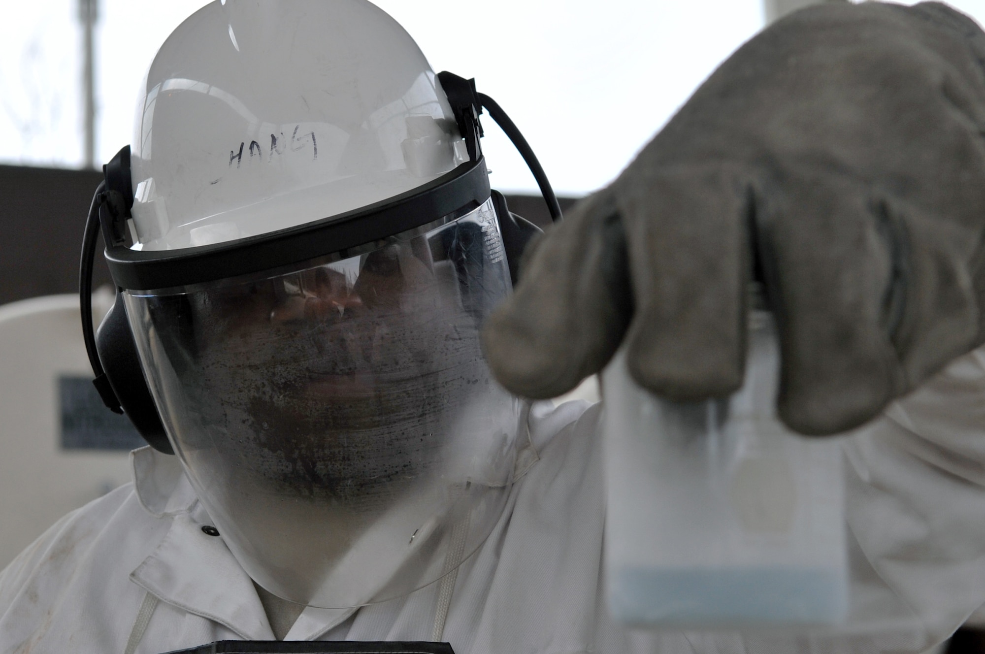 Staff Sgt. James Gardner, 51st Logistics Readiness Squadron fuels cryogenics technician, holds a beaker containing liquid oxygen after it has been expelled from a tank here, April 9, 2012. Gardner waits for the liquid to stop boiling before performing and odor test to determine the quality. (U.S. Air Force photo/Staff Sgt. Craig Cisek)