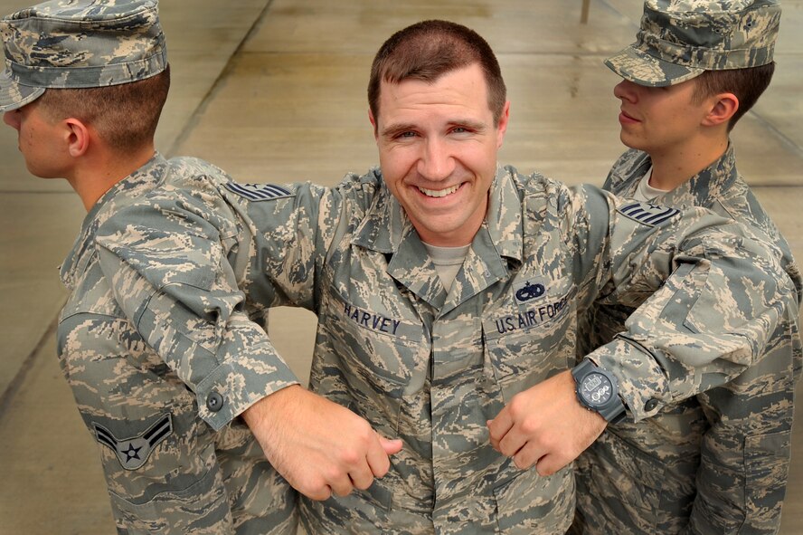 U.S. Air Force Tech Sgt. Shane Harvey, Airman Leadership School instructor, poses between two Airmen to have a personality portrait taken, March 5, 2012, Shaw Air Force Base, S.C. Harvey has been an ALS instructor for just over three years. His preferred teaching method is a balance between humor and firm instruction. (U.S. Air Force photo by Senior Airman Kenny Holston)