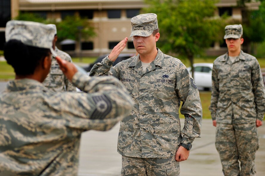 U.S. Air Force Tech. Sgt. Shane Harvey, Airman Leadership School instructor, renders a salute to Tech. Sgt. Thyiatira Singleton, ALS instructor during a retreat ceremony, March 5, 2012, Shaw Air Force Base, S.C. Harvey has been an ALS instructor for just over three years. His preferred teaching method is a balance between humor and firm instruction. (U.S. Air Force photo by Senior Airman Kenny Holston)




