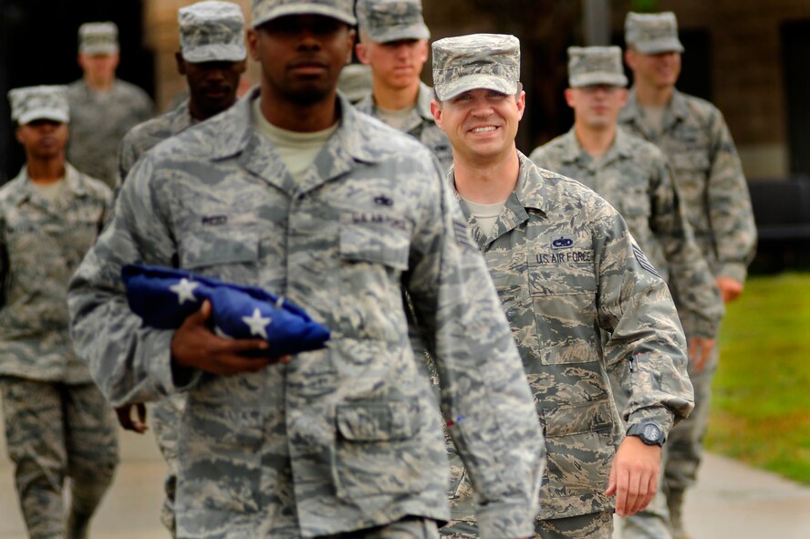 U.S. Air Force Tech Sgt. Shane Harvey, Airman Leadership School instructor, wears a smile on his face as he makes his way to the drill pad for retreat with his fellow ALS instructors and Airmen, March 5, 2012, Shaw Air Force Base, S.C. Harvey has been an ALS instructor for just over three years. His preferred teaching method is a balance between humor and firm instruction. (U.S. Air Force photo by Senior Airman Kenny Holston)