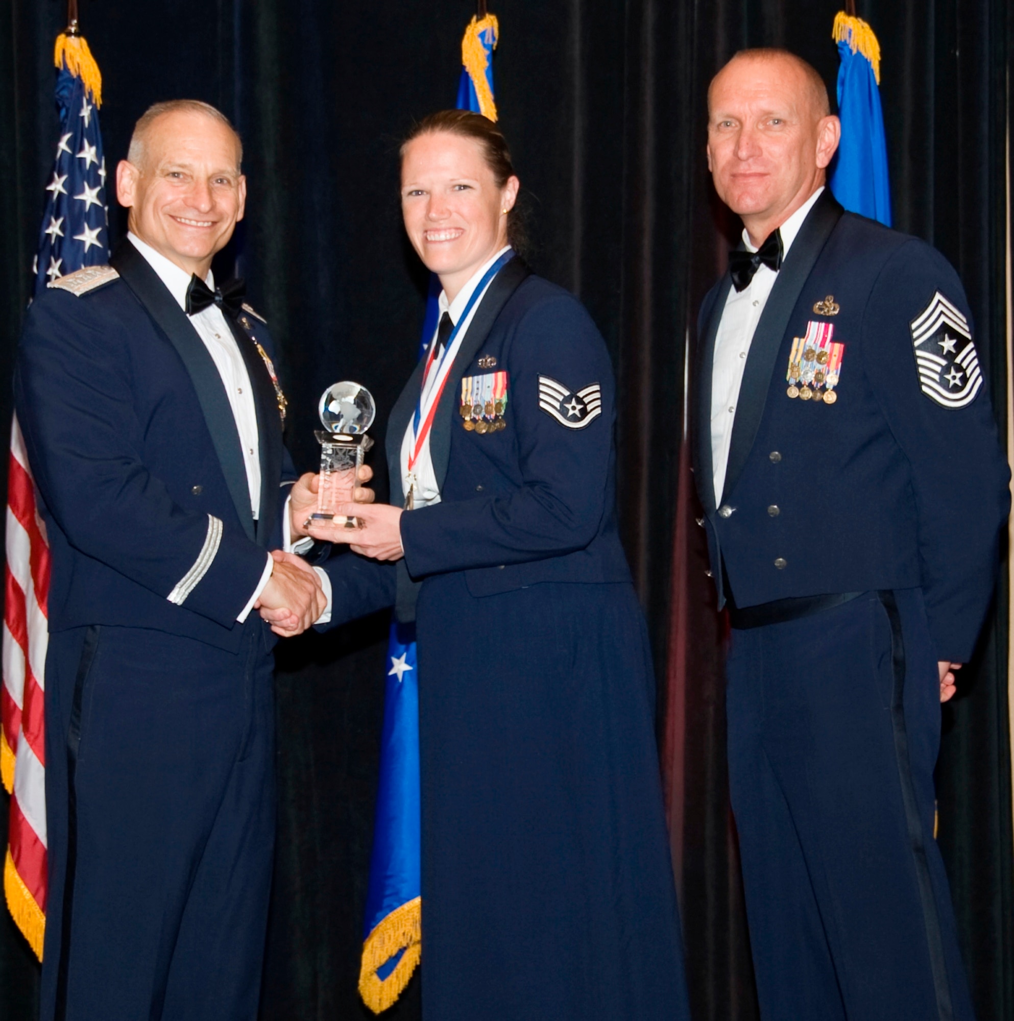Staff Sgt. Andrea L. Scheving, 509th Bomb Wing air traffic controller, receives the honor of Air Force Global Strike Command Outstanding Non-Commissioned Officer in Charge from AFGSC commander Lt. Gen. Jim Kowalski and Chief Master Sgt. Brian Hornback, command chief AFGSC, here April 5. (U.S. Air Force photo by Airman 1st Class Benjamin Gonsier)