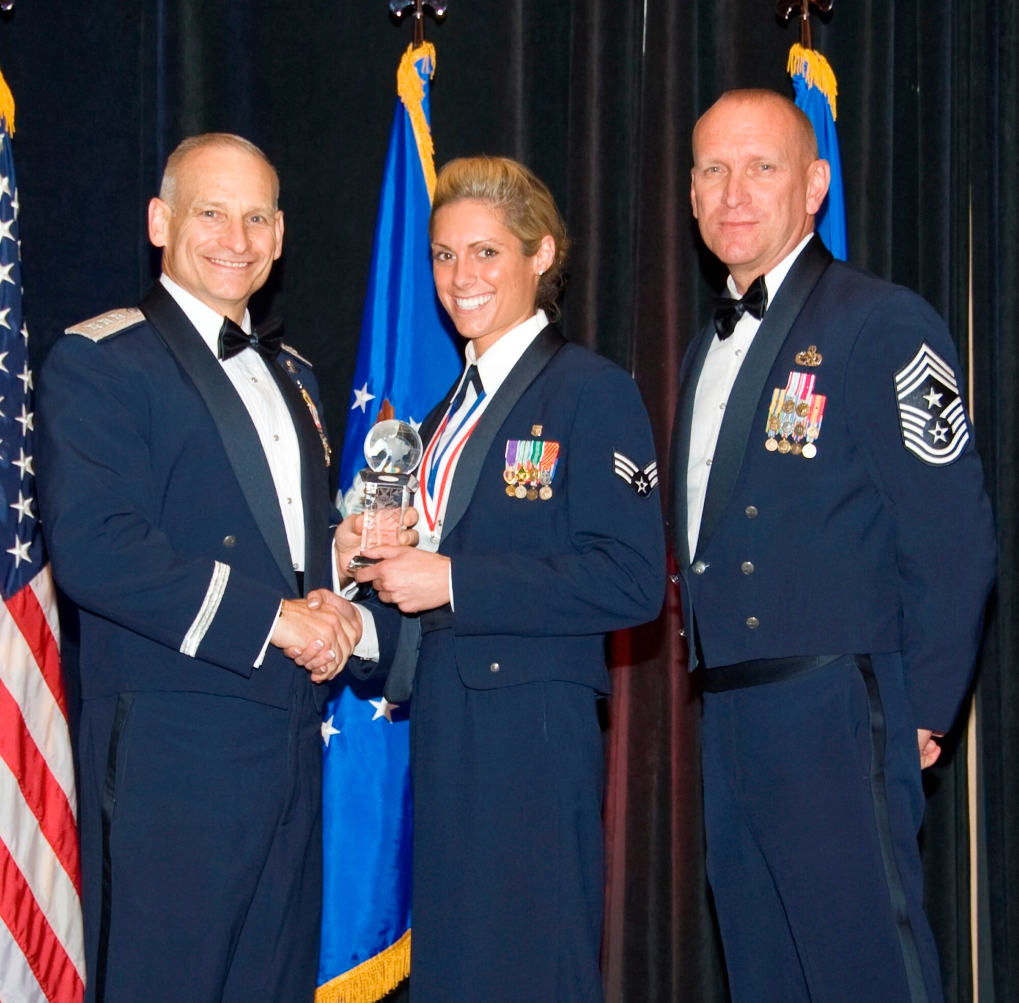 Lt. Gen. Jim Kowalski, commander Air Force Global Strike Command and Chief Master Sgt. Brian Hornback, command chief AFGSC, present Senior Airman Bryenna L. Brooks, 2d Medical Operations Squadron aerospace medical services technician, with AFGSC Outstanding Airman of the Year honors here April 5. (U.S. Air Force photo by Airman 1st Class Benjamin Gonsier)