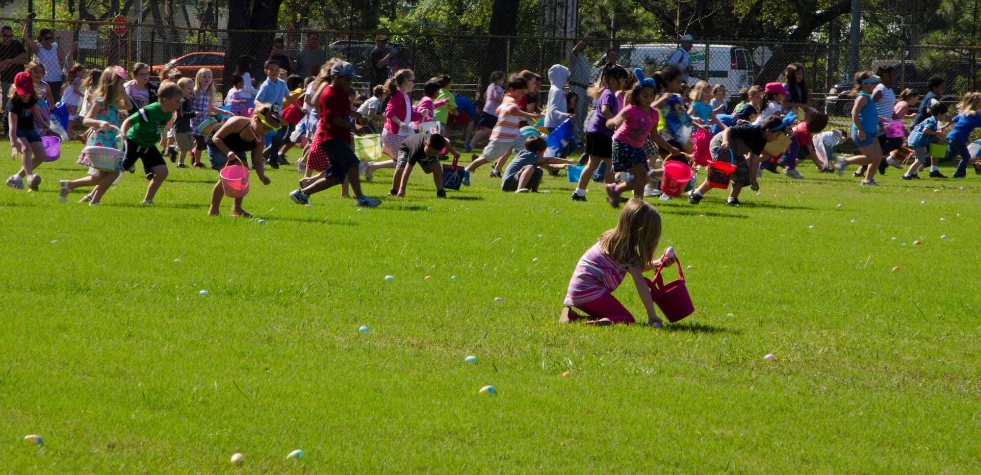 Dozens of children seek out eggs during an Easter egg hunt at the base community park at Hurlburt Field, Fla., April 7, 2012.  More than 14,000 eggs were collected by more than 1,000 children within the first two minutes of the hunt. (U.S. Air Force photo/Senior Airman John Bainter)(Released)