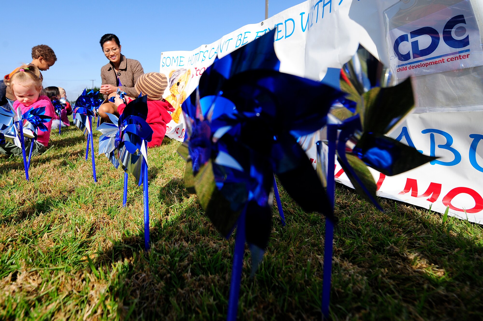 VANDENBERG AIR FORCE BASE, Calif.-- Children from the Child Development Center plant pinwheels in front of the CDC during the Child Abuse Prevention Month campaign here Monday, Apr. 9, 2012. The pinwheel is a symbol that represents youth and childhood. (U.S. Air Force photo/Staff Sgt. Andrew Satran) 

 