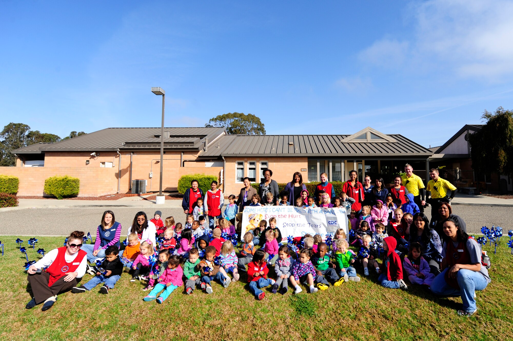 VANDENBERG AIR FORCE BASE, Calif.-- Children from the Child Development Center pose for a photo with members of the CDC staff, Family Advocacy and 30th Security Forces Squadron personnel during the Child Abuse Prevention Month campaign here Monday, Apr. 9, 2012. National Child Abuse Prevention month focuses on promoting awareness for child safety to prevent abuse and neglect toward children. (U.S. Air Force photo/Staff Sgt. Andrew Satran) 

 