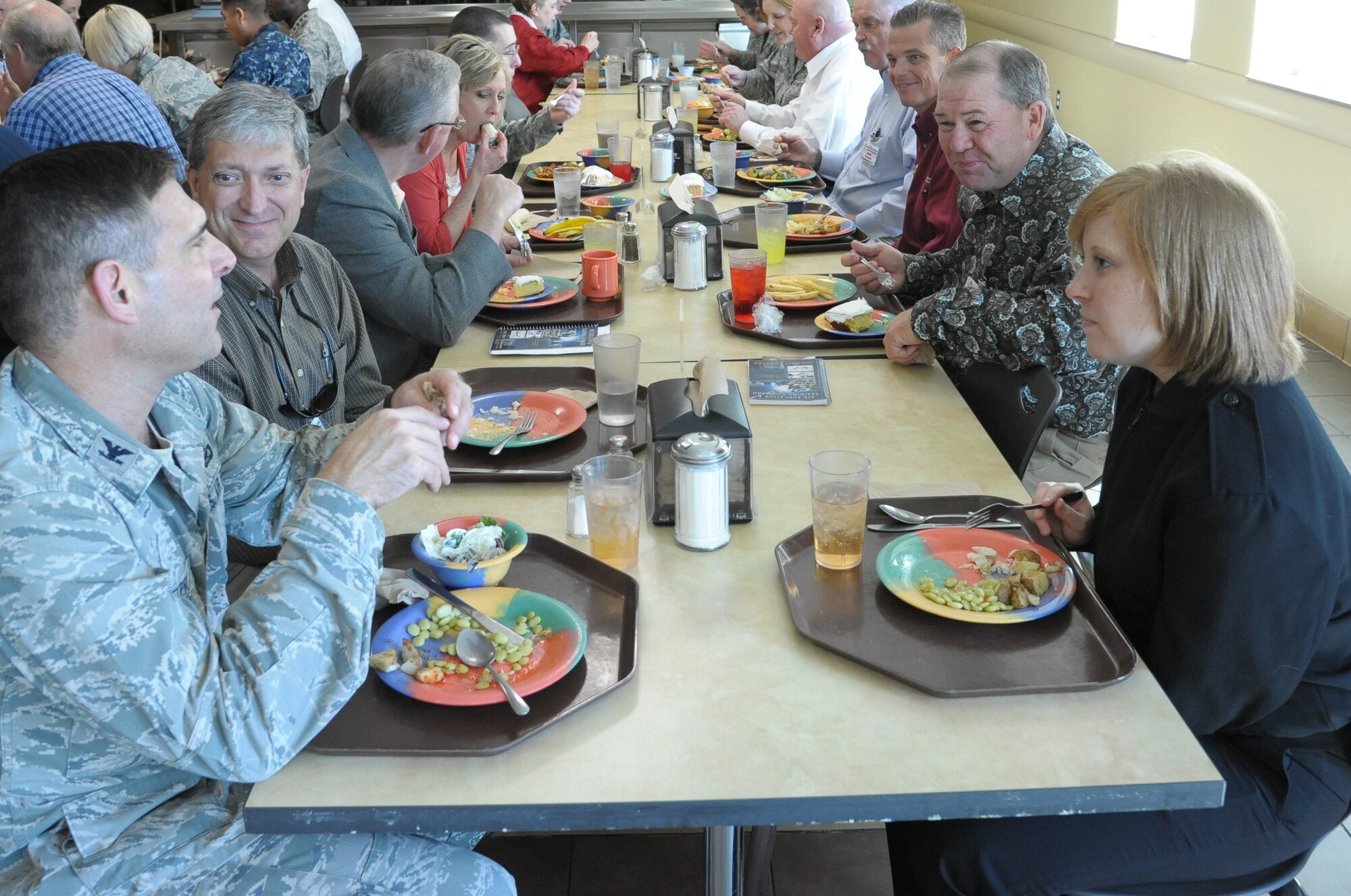Lynn Robinson (left), from Columbus Air Force Base, Miss., and Randy Catlin
(right), from Sheppard AFB, Texas, listen to Col. Stephen Clutter, Air
Education and Training Command director of public affairs, during lunch with
students at the Medical Education and Training Campus on Fort Sam Houston,
Texas, March 21. Robinson and Catlin are newly appointed AETC Commander's
Group members.  (U.S. Air Force photo by Joel Martinez)
