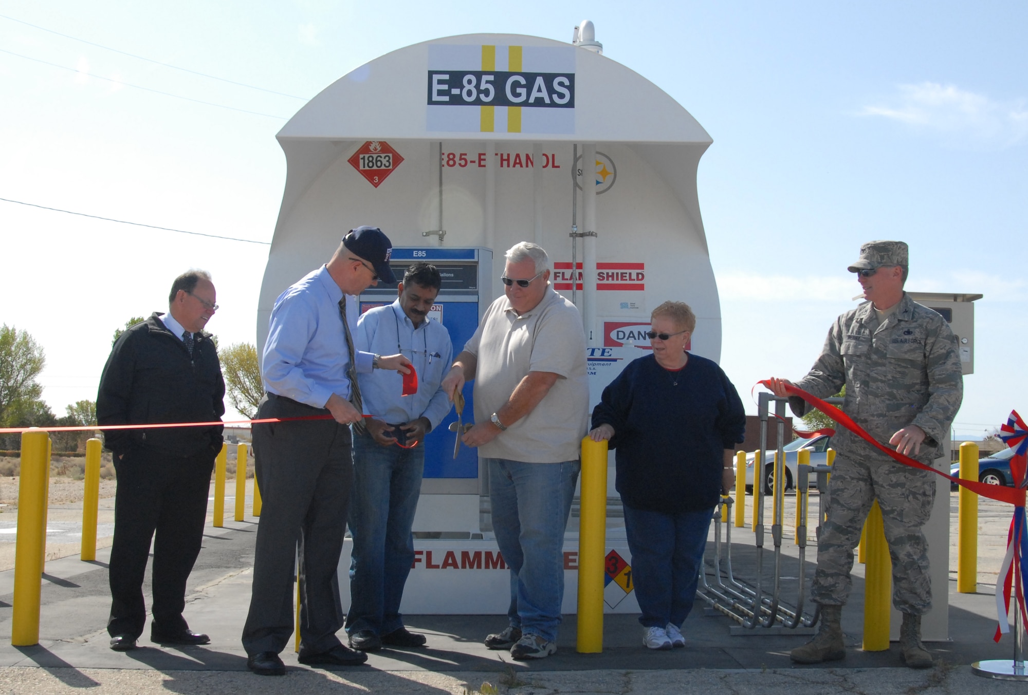 Team Edwards members cut pieces of the ceremonial ribbon that officially opened the new E85 fuel tank at the Government Gas Station April 6.  E85, commonly called fuel ethanol, is made of 85-percent ethanol blended with 15-percent gasoline and is more environmentally friendly than regular gasoline. Pictured from left: Randy Beckett, 95th Civil Engineering Division deputy director; James Judkins, 95th CE director; Satwaji Kumar, 95th CE Infrastructure Systems engineer; Cliff Cunningham, 95th Mission Support Group fuels testing and technical advisor; Sandra Sergent, 95th MSG Logistics and Readiness division chief; and Col. Buddy Berry, 95th MSG commander.  (Air Force photo by Kenji Thuloweit) 