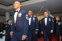 Chief Master Sgt. Lonnie Slater (front) and Chief Master Sgt. James Cody (right), Air Education and Training command command chiefs, escort retired Maj. Gen Alfred K. Flowers during the Order of the Sword ceremony April 6 at Joint Base San Antonio-Randolph, Texas. The Order of the Sword was established by the Air Force enlisted force to recognize and honor senior military officers and civilian equivalents. (U.S. Air Force photo by Joel Martinez)