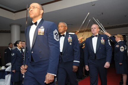 Chief Master Sgt. Lonnie Slater (front) and Chief Master Sgt. James Cody (right), Air Education and Training command command chiefs, escort retired Maj. Gen Alfred K. Flowers during the Order of the Sword ceremony April 6 at Joint Base San Antonio-Randolph, Texas. The Order of the Sword was established by the Air Force enlisted force to recognize and honor senior military officers and civilian equivalents. (U.S. Air Force photo by Joel Martinez)