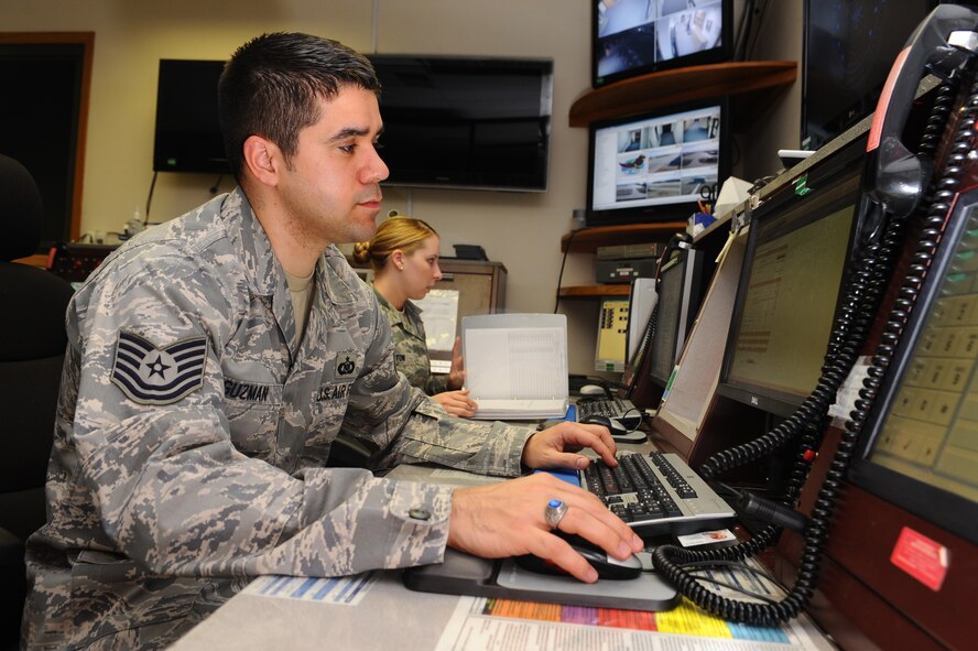 Tech. Sgt. Brett Guzman, 28th Bomb Wing NCO in charge of command post operations, and Senior Airman Kaitlyn Hilton, 28th BW command post controller, monitor information in the base command post at Ellsworth Air Force Base, S.D., March 29, 2012. Command post controllers manage a variety of operations and support to proper agencies as well as provide command and control information 24-hours-a-day, seven days a week. (U.S. Air Force photo by Airman 1st Class Zachary Hada/Released)