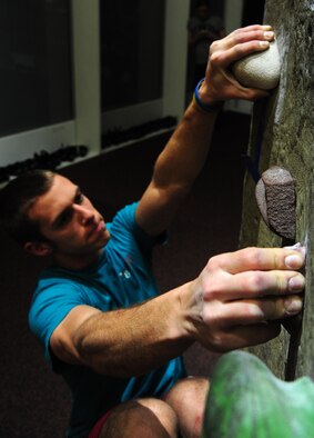 WARRENSBURG, Mo. – Darius Schnieders, University of Central Missouri sophomore, climbs a rock wall during a “Late Night at UCM” event at UCM in the recreation center March 16. Wing It finds, plans and sponsors alcohol-free events for 18 to 20 year old Airmen and college students living in the Whiteman AFB local area. (U.S. Air Force photo/Senior Airman Nick Wilson)