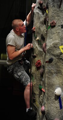 WARRENSBURG, Mo. -- Airman 1st Class Trevor Young, 509th Aircraft Maintenance Squadron hydraulics systems apprentice, climbs a rock wall during a “Late Night at UCM” event at the University of Central Missouri in the recreation center March 16. Wing It is an organization that reduces underage drinking among the 18 to 20 year-old Whiteman AFB age group and sponsors events that provide an alternative to drinking. (U.S. Air Force photo/Senior Airman Nick Wilson)  