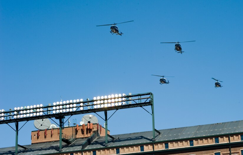 BALTIMORE, Md. -- A formation of 1st Helicopter Squadron UH-1N Iroquois from Joint Base Andrews, Md., fly in formation over the Camden Yards Stadium during the last note of The National Anthem at the Baltimore Orioles' season opener April 4.  These patriotic displays of military strength and precision require a considerable amount of advanced planning and coordination, but are an important part of showing the American people that their Air Force is the best in the world.   (Photo/Bobby Jones)