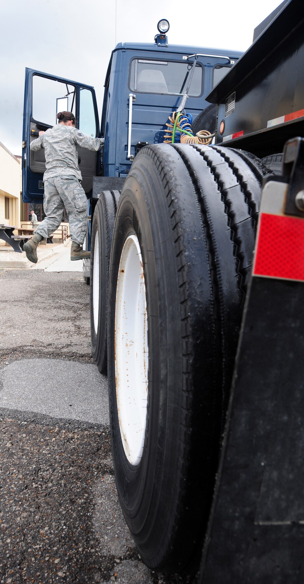 WHITEMAN AIR FORCE BASE, Mo. -- Senior Airman Stacy Schumpert, 509th Logistics Readiness Squadron operator records and licensing journeyman, inspects a ten-ton tractor March 23. Before, during and after trips, it’s important to inspect the vehicles for any damages to ensure the reliability of the vehicle and safety of the members driving it. (U.S. Air Force photo/Senior Airman Nick Wilson)