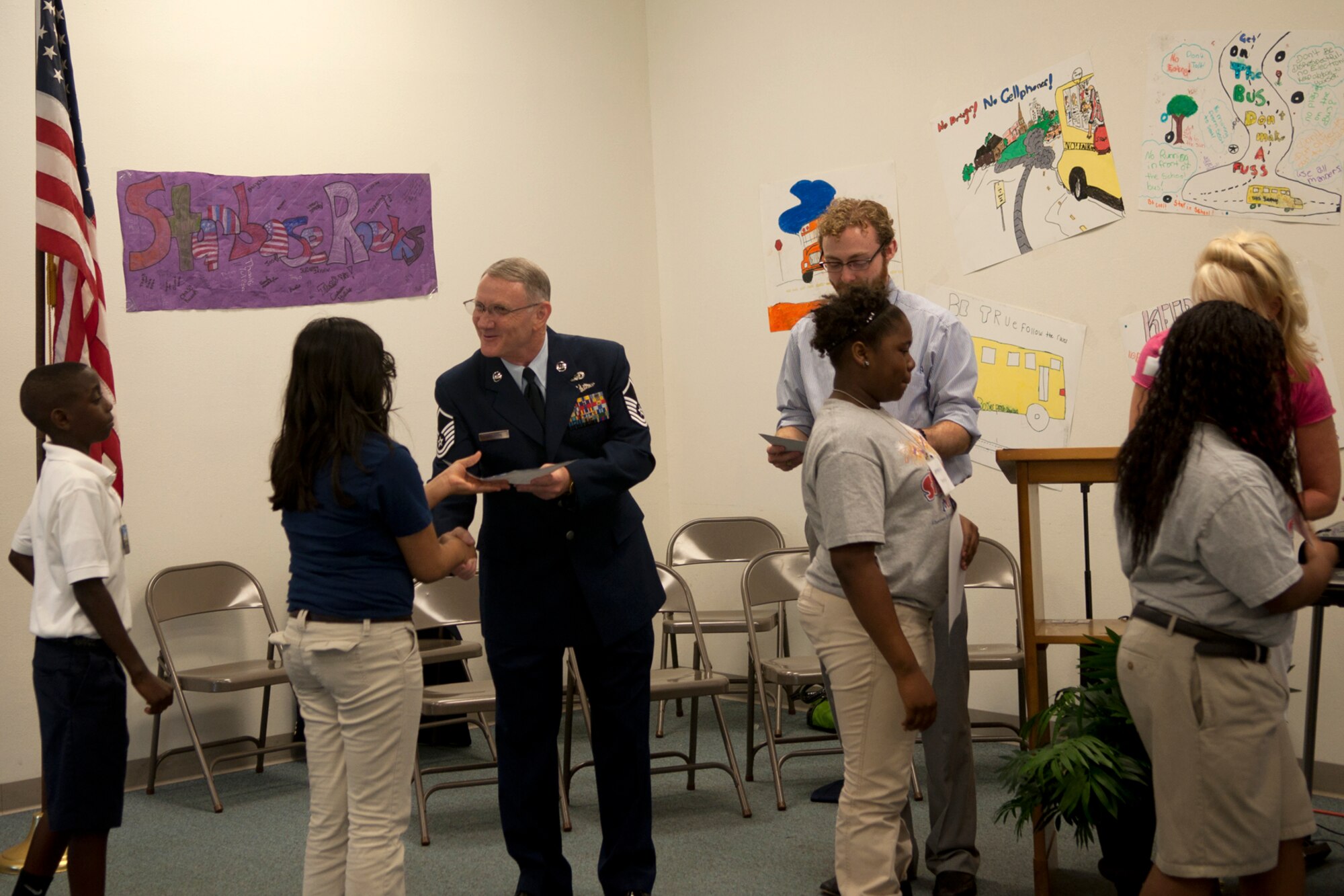Master Sgt. Jeff Walston, a public affairs technician assigned the 307th Bomb Wing, Barksdale Air Force Base, La., hands out graduation certificates and congratulates 5th graders at Central Park Elementary school in Bossier City, La., April 5, 2012. Walston was the guest speaker for a graduation ceremony at the school.  The students completed an exciting 25-hour hands on/minds on aviation and aerospace course offered to area 5th grade students and their teachers by STARBASE Louisiana, at Barksdale. The program is one of 60 national STARBASE sites, and is sponsored by the 307th BW of the Air Force Reserve Command. Many U.S. Air Force servicemembers volunteer to speak at the graduation ceremonies to help motivate the students to continue their education. This was Walston’s third graduation ceremony. Speakers are always welcomed and always needed. Any officer or senior non-commissioned officer interested in motivating these young people should contact the 307th Bomb Wing Public Affairs Office at 318-529-3023 to be put on the speaker’s list. (Courtesy photo by Eva Klimentova)