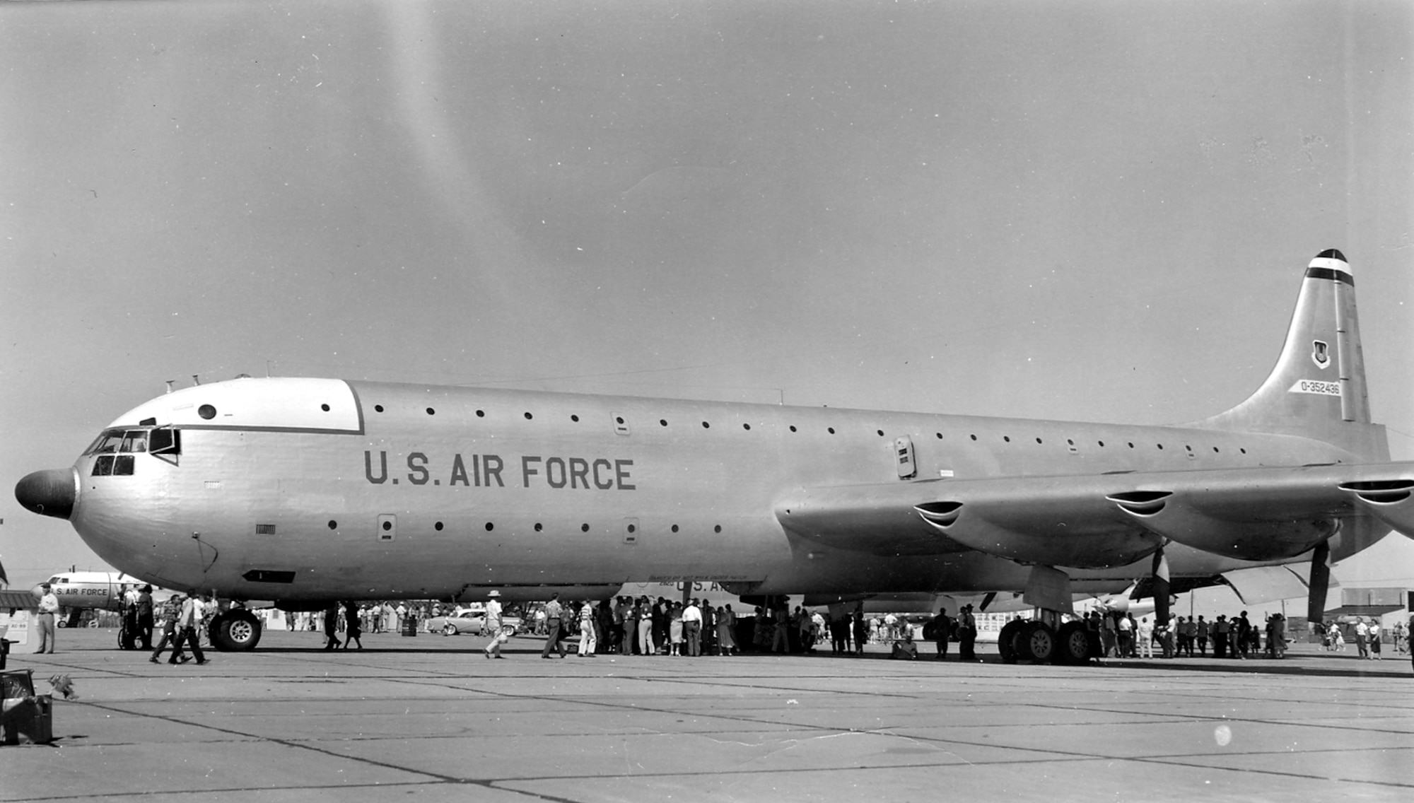 In 1953, an AN/APS-42 weather radar with its distinctive “thimble” radome (the black dome on the nose of the aircraft) was installed.  The spectators are looking into the cargo bay, which used a special hoist to load cargo. (U.S. Air Force photo).