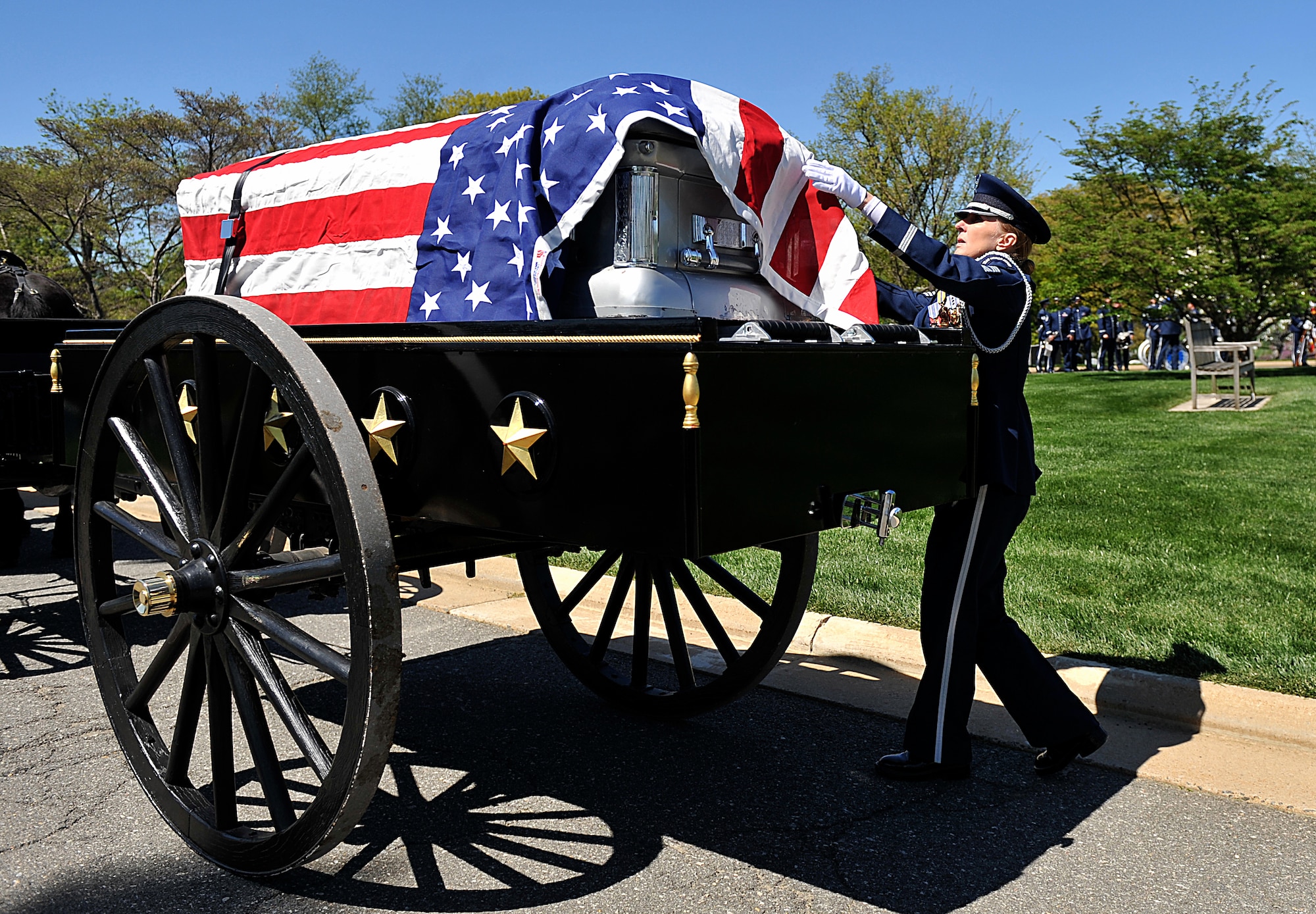 Chief Master Sgt. Diane Munson straightens an American flag on a casket that will contain the remains of Tech. Sgt. Allen J. Avery during Avery's burial ceremony at Arlington National Cemetery, Va., April 6, 2012. Avery was part of a combat search and rescue mission aboard an HH-53C Super Jolly Green Giant helicopter when they were shot down over Quang Tri province, South Vietnam, April 6, 1972.  Munson is with the U.S. Air Force Honor Guard. (U.S. Air Force photo by Val Gempis)
