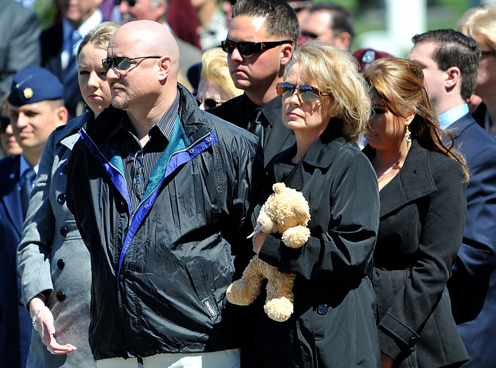 Debbie McBride, holding a teddy bear, and family members watch as U.S. Air Force honor guard Airmen place an urn containing the remains of her father, Tech. Sgt. Allen J. Avery, inside a casket during Avery's burial ceremony at Arlington National Cemetery, Va., April 6, 2012. Avery was part of a combat search and rescue mission aboard an HH-53C Super Jolly Green Giant helicopter when they were shot down over Quang Tri province, South Vietnam, April 6, 1972. (U.S. Air Force photo by Val Gempis)