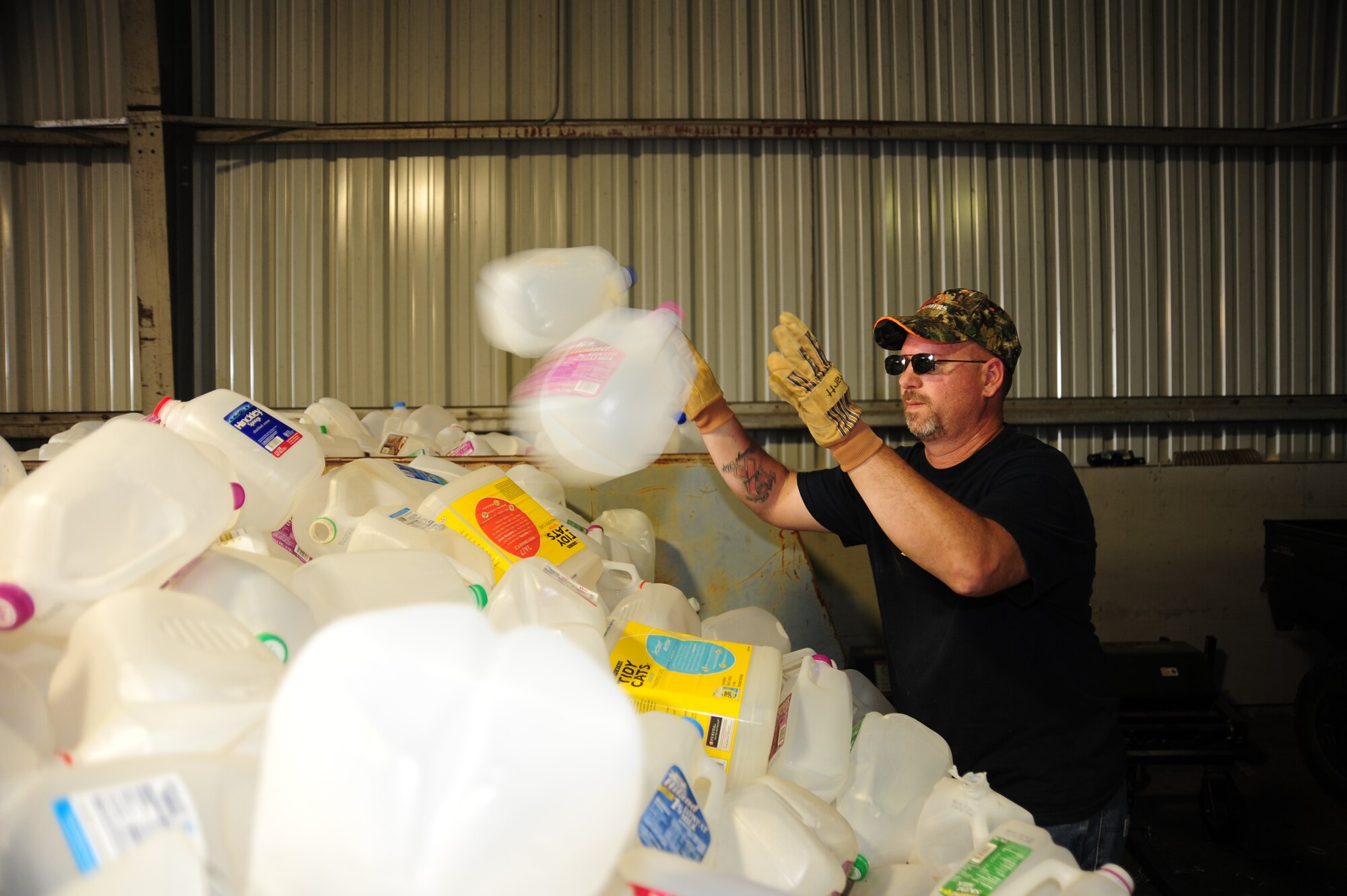WHITEMAN AIR FORCE BASE, Mo. – Jeff Willming, 509th Force Support Squadron material handler, puts plastic milk cartons in a recycling bin March 29 at the recycling center. In 2011, Whiteman Air Force Base recycled more than 600 tons of materials and earned $170 thousand in revenue. (U.S. Air Force photo/Senior Airman Nick Wilson)