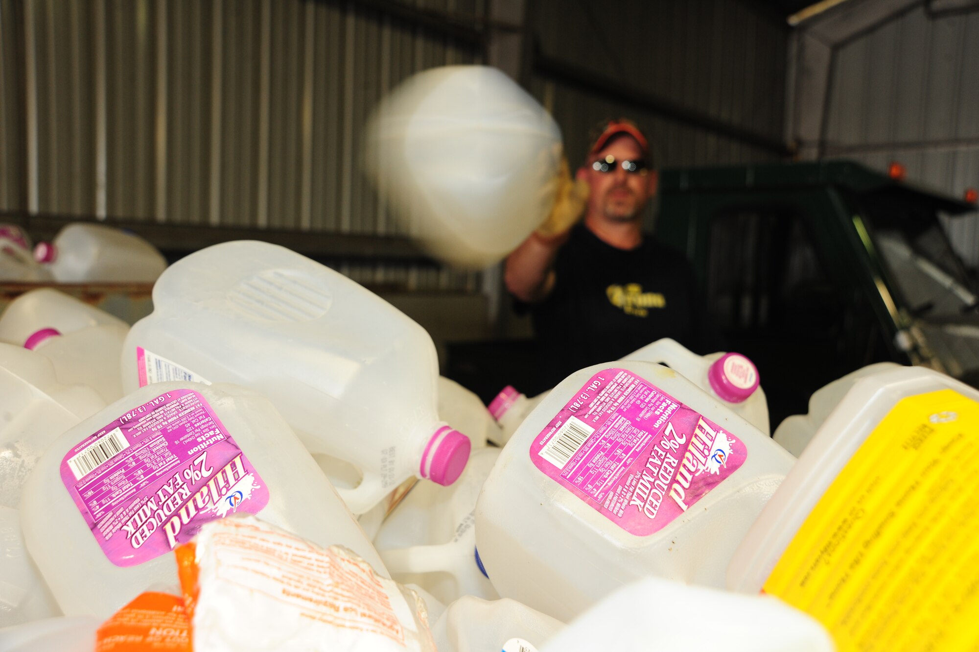 WHITEMAN AIR FORCE BASE, Mo. – Jeff Willming, 509th Force Support Squadron material handler, puts plastic milk cartons in a recycling bin March 29 at the recycling center. Recycling plastic saves twice as much energy as burning it in an incinerator, according to recycling-revolution.com. (U.S. Air Force photo/Senior Airman Nick Wilson)
