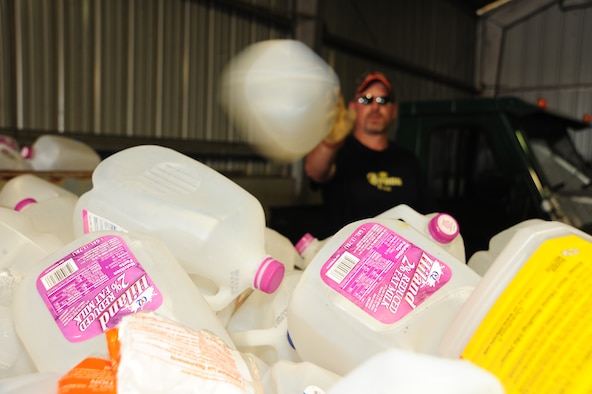 WHITEMAN AIR FORCE BASE, Mo. – Jeff Willming, 509th Force Support Squadron material handler, puts plastic milk cartons in a recycling bin March 29 at the recycling center. Recycling plastic saves twice as much energy as burning it in an incinerator, according to recycling-revolution.com. (U.S. Air Force photo/Senior Airman Nick Wilson)