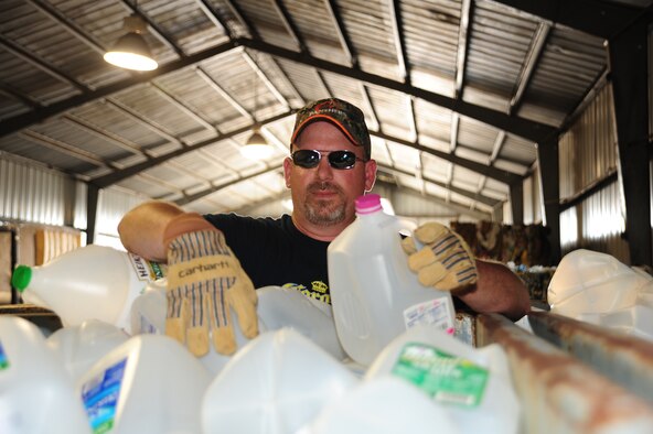 WHITEMAN AIR FORCE BASE, Mo. – Jeff Willming, 509th Force Support Squadron material handler, puts plastic milk cartons in a recycling bin March 29 at the recycling center. Each year the U.S. produces enough plastic to shrink-wrap Texas, according to thinkgreen.com. (U.S. Air Force photo/Senior Airman Nick Wilson)