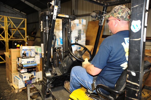 WHITEMAN AIR FORCE BASE, Mo. – Jeff Willming, 509th Force Support Squadron material handler, drives a forklift to move a pallet of printer cartridges March 29 at the recycling center. The recycling center saves the Air Force an average of $60K each year by recycling biodegradable items. (U.S. Air Force photo/Senior Airman Nick Wilson)