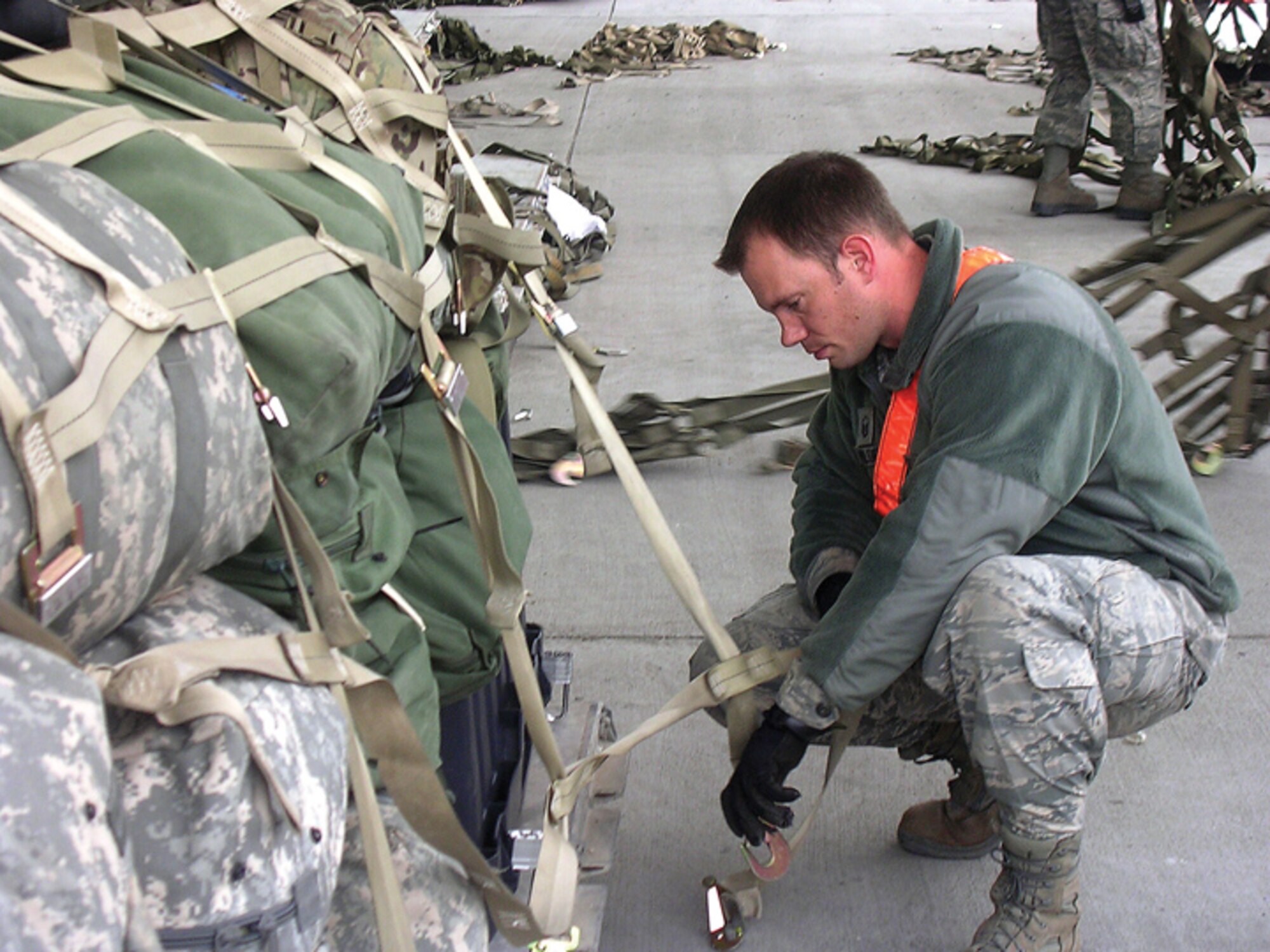 Deployed members of the 25th Aerial Port Squadron are proving the truth of the unit motto, "Anytime ... Anywhere." Master Sgt. Jeffery Holder secures a baggage pallet.