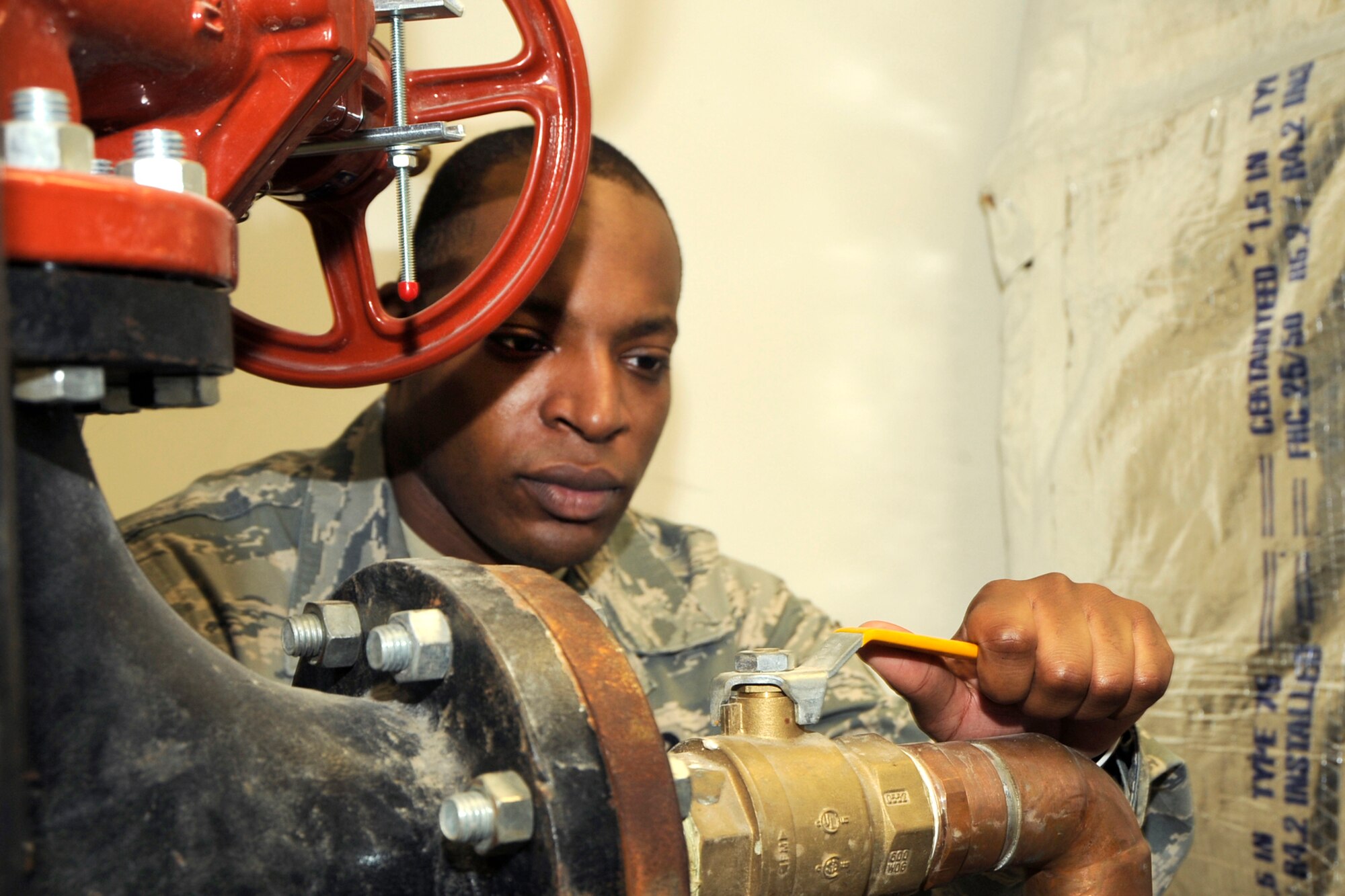 SSgt. Henry McCall, a Water & Fuels System Maintenance specialist with the 127th Civil Engineer Squadron, adjusts a valve on a water supply line. McCall is a member of the Michigan Air National Guard at Selfridge Air National Guard Base, Mich. (U.S. Air Force photo by John S. Swanson)