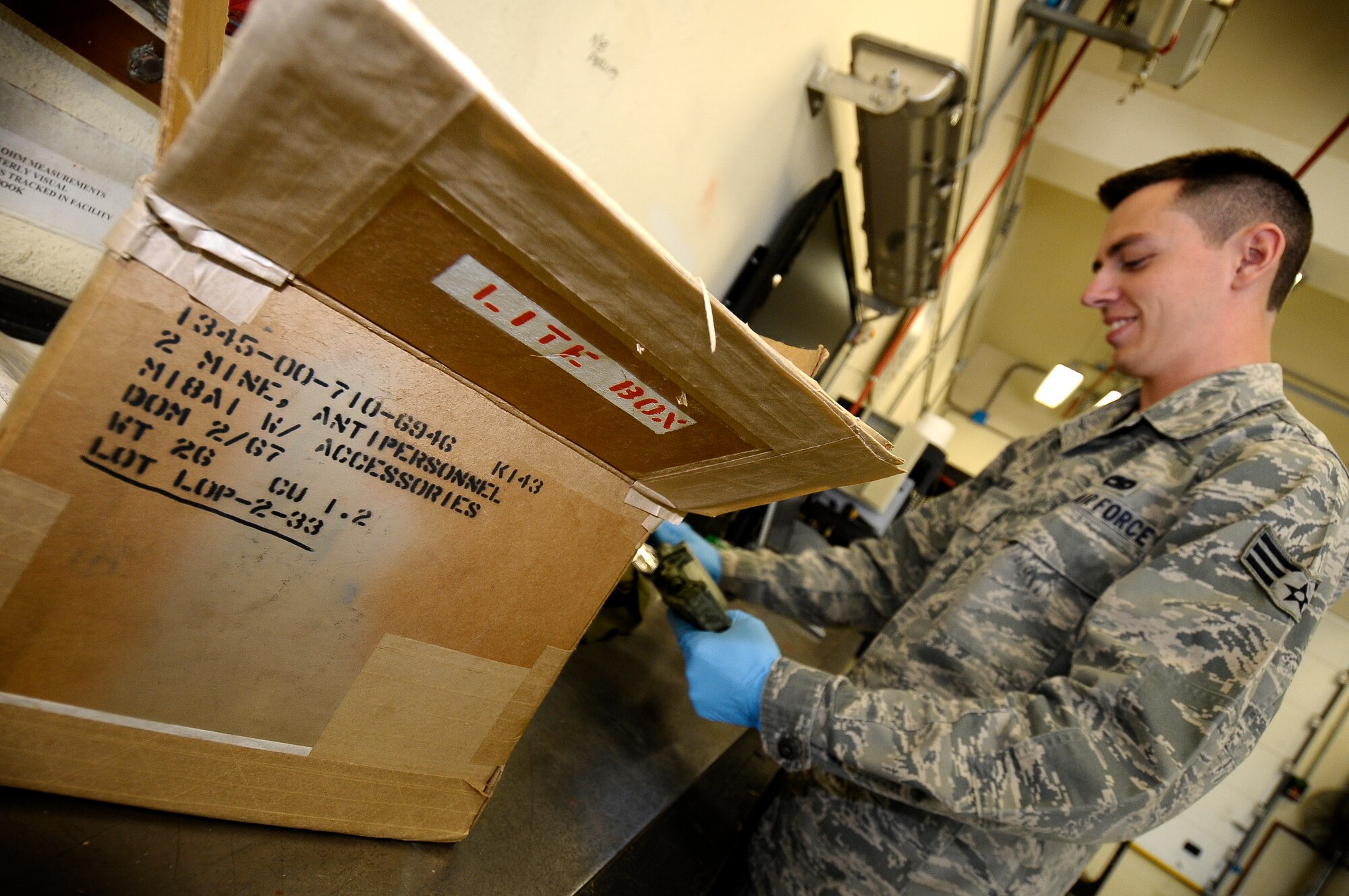 Senior Airman Ralph Simons, 31st Munitions Squadron munitions inspector examines an anti-personnel mine April 2 at Aviano Air Base, Italy. Members of the 31st MUNS recently earned the 2011 Air Force Maintenance Effectiveness Award. The squadron acted as the lead NATO munitions unit during Operation Odyssey Dawn, building 557 bombs for the operation. The unit also participated in Operation Unified Protector, providing munitions for 1,800 sorties flown by joint and coalition partners deployed to Aviano. (U.S. Air Force photo/Senior Airman Katherine Windish)