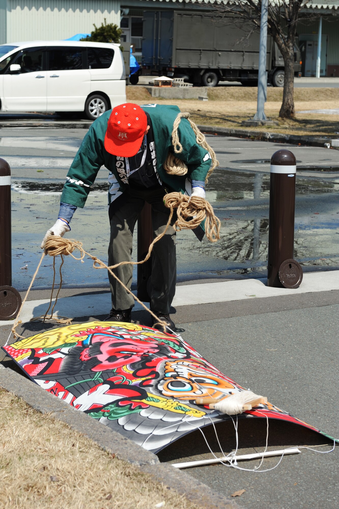 A member from the Aomori Kite making and display team prepares his kite during the 25th Annual Japan Day at Misawa Air Base, Japan, April 7, 2012. Kite flying became popular in Japan during the Edo period.  (U.S. Air Force photo by Airman 1st Class Kia Atkins/Released)