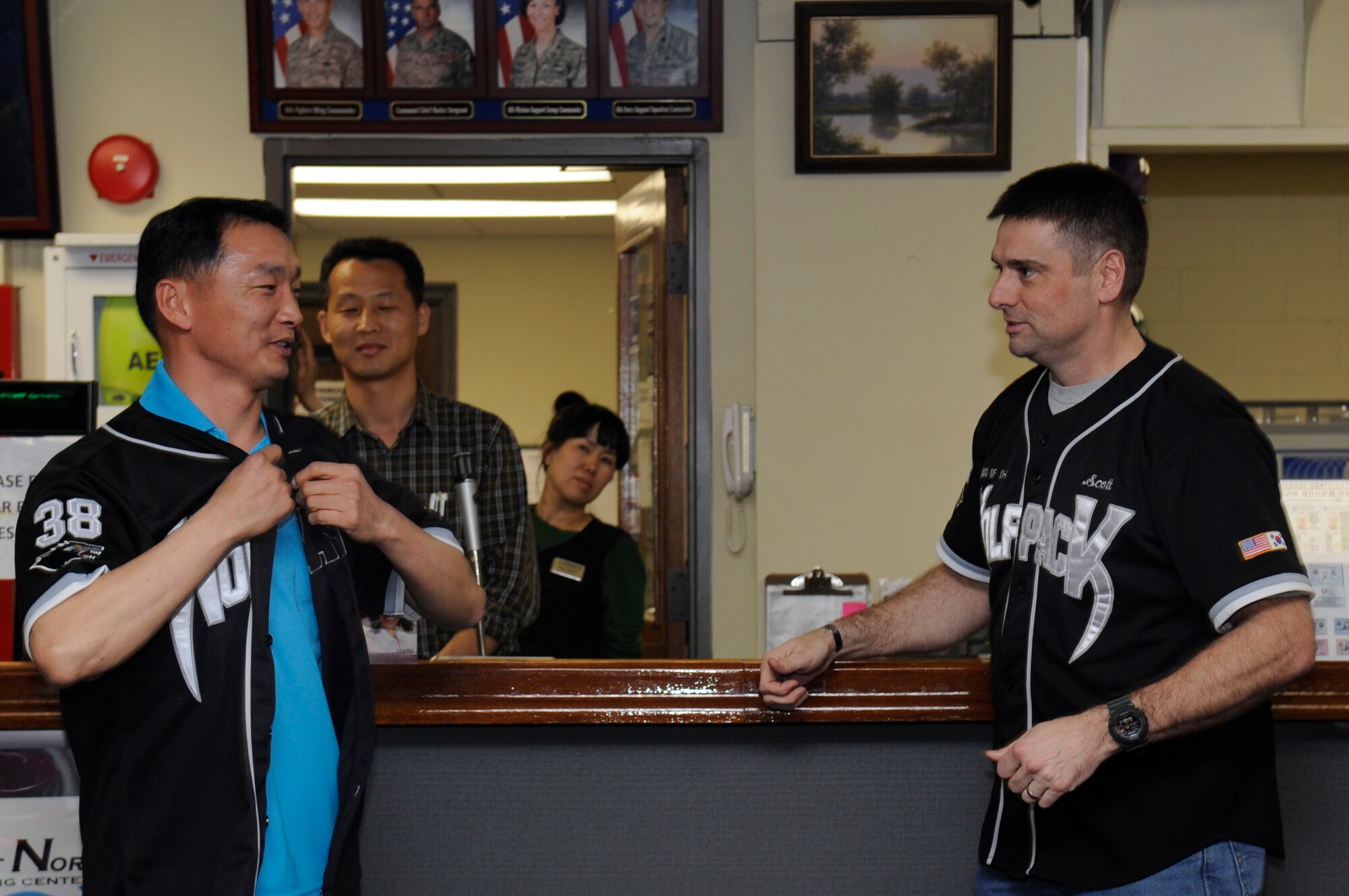 CMSgt. Ki Yeol Kim, left, Republic of Korea Air Force 38th Fighter Group command chief, puts on a Wolf Pack jersey presented to him by Chief Master Sgt. Scott Delveau, right, 8th Fighter Wing command chief April 2, 2012 at the Take it North Bowling Center on Kunsan Air Base, ROK. The two command chiefs bowled with other senior enlisted members from Kunsan AB, during a ROKAF/U. S. Air Force Enlisted Friendship event, which helps enlisted members build friendships with host country allies. 