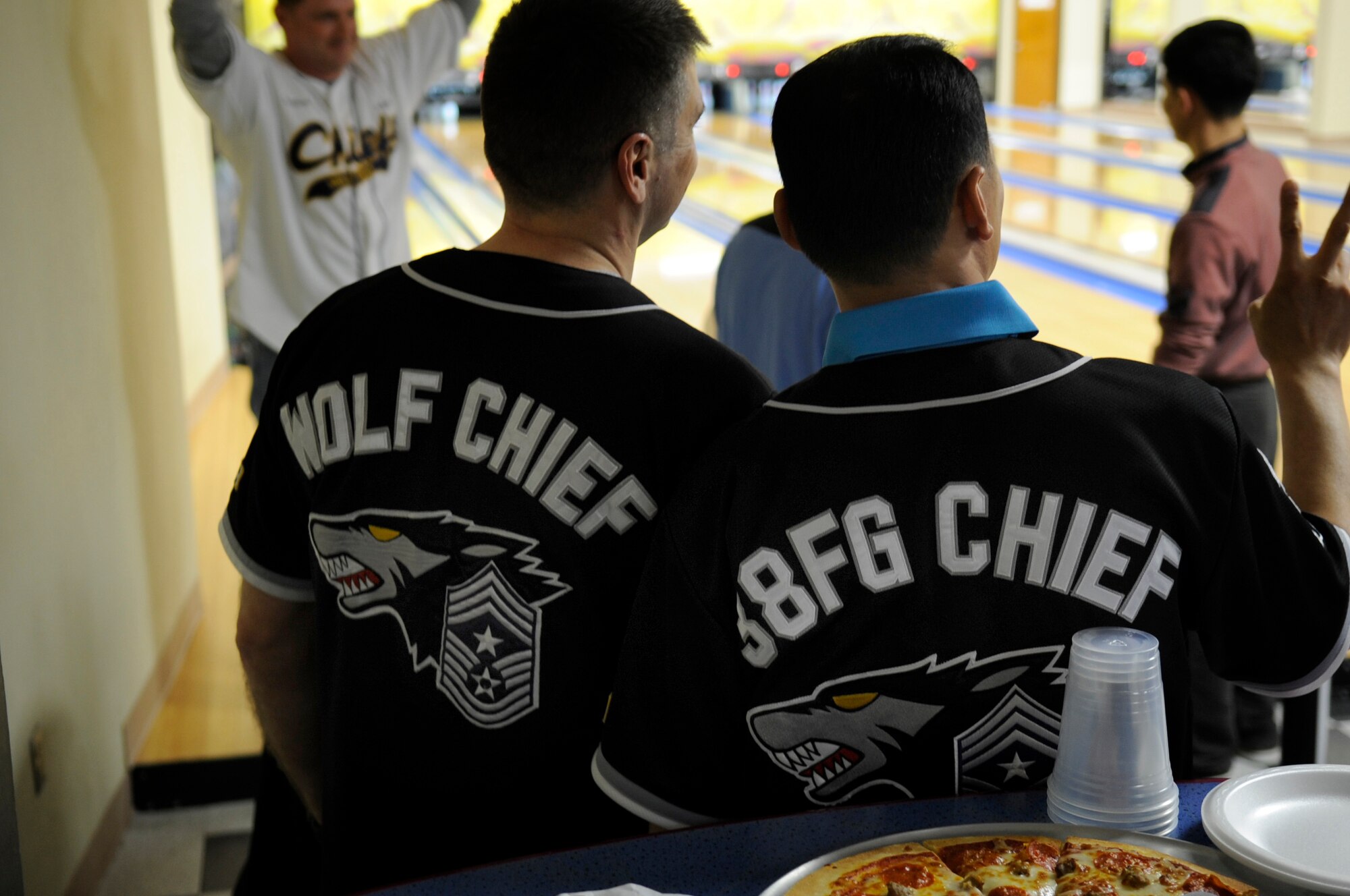Chief Master Sgt. Scott Delveau, left, 8th Fighter Wing command chief, poses for a picture with CMSgt. Ki Yeol Kim, Republic of Korea 38th Fighter Group command chief, April 2, 2012 at the Take it North Bowling Center on Kunsan Air Base, ROK. The two command chiefs bowled with other senior enlisted members from Kunsan AB, during a ROKAF/U. S. Air Force Enlisted Friendship event. Chief Kim was presented with a Wolf Pack jersey as a gesture of goodwill and friendship and bowled one of the highest scores with a 253.