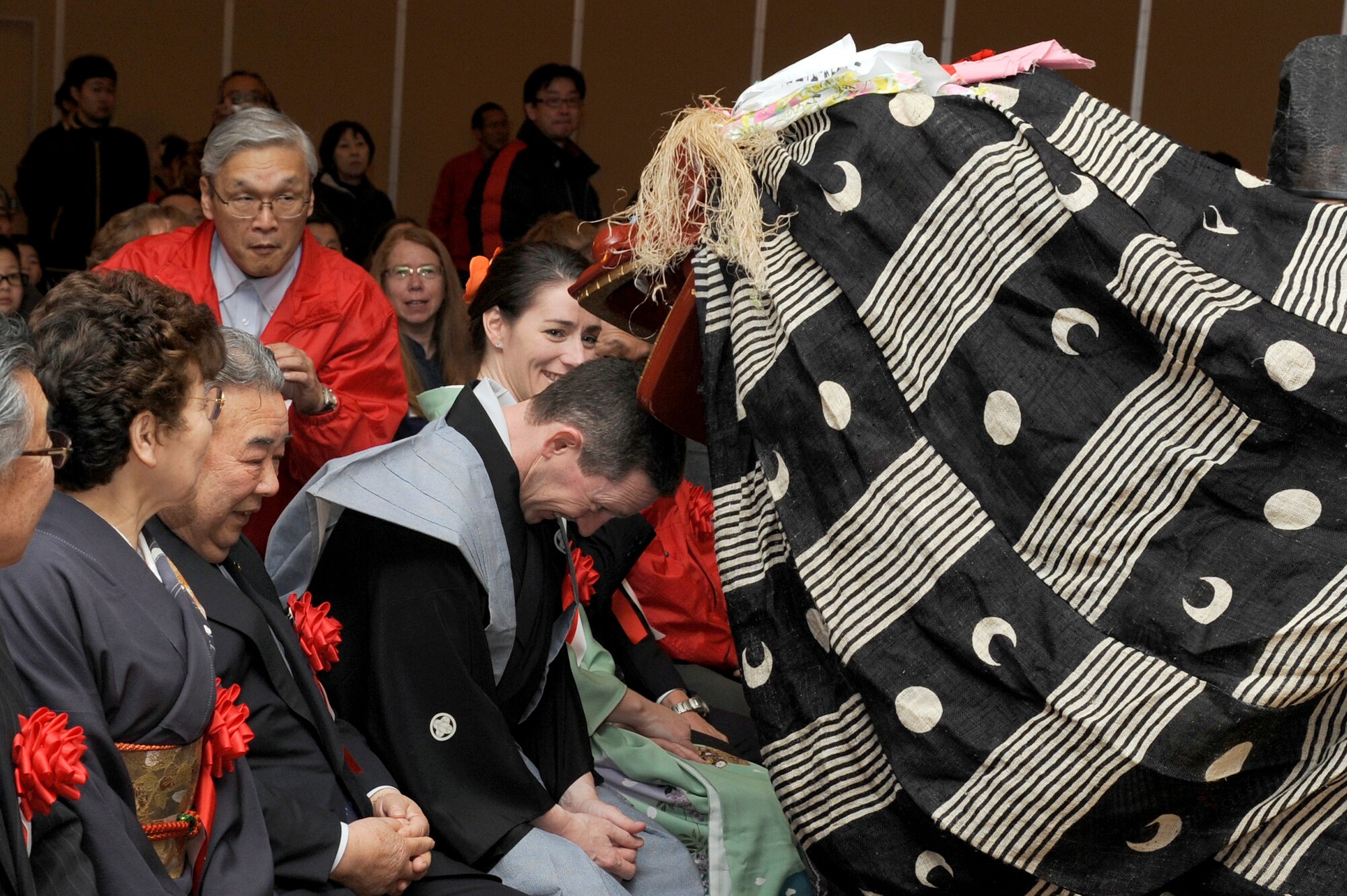 U.S. Air Force Col. Michael D. Rothstein, 35th Fighter Wing commander, receives good luck from a lion during the Kagura sacred music and dance performance part of the 25th Annual Japan Day opening ceremony at Misawa Air Base, Japan, April 7, 2012. The event featured more than 600 Japanese artisans, craftsmen, entertainers and cooks. (U.S. Air Force photo by Tech. Sgt. Marie Brown/Released)
