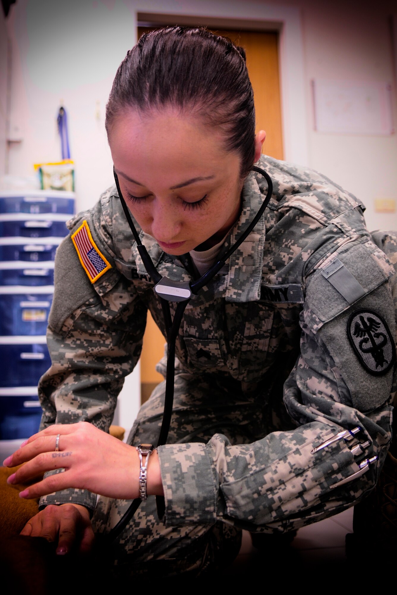 Army Sgt. Juliane Barry, Aviano veterinary treatment facility NCO in charge, listens to a dog’s lungs March 30 at Aviano Air Base, Italy. Barry does this as part of a routine checkup to ensure the animal has no health problems. (U.S. Air Force photo/Airman 1st Class Briana Jones)  