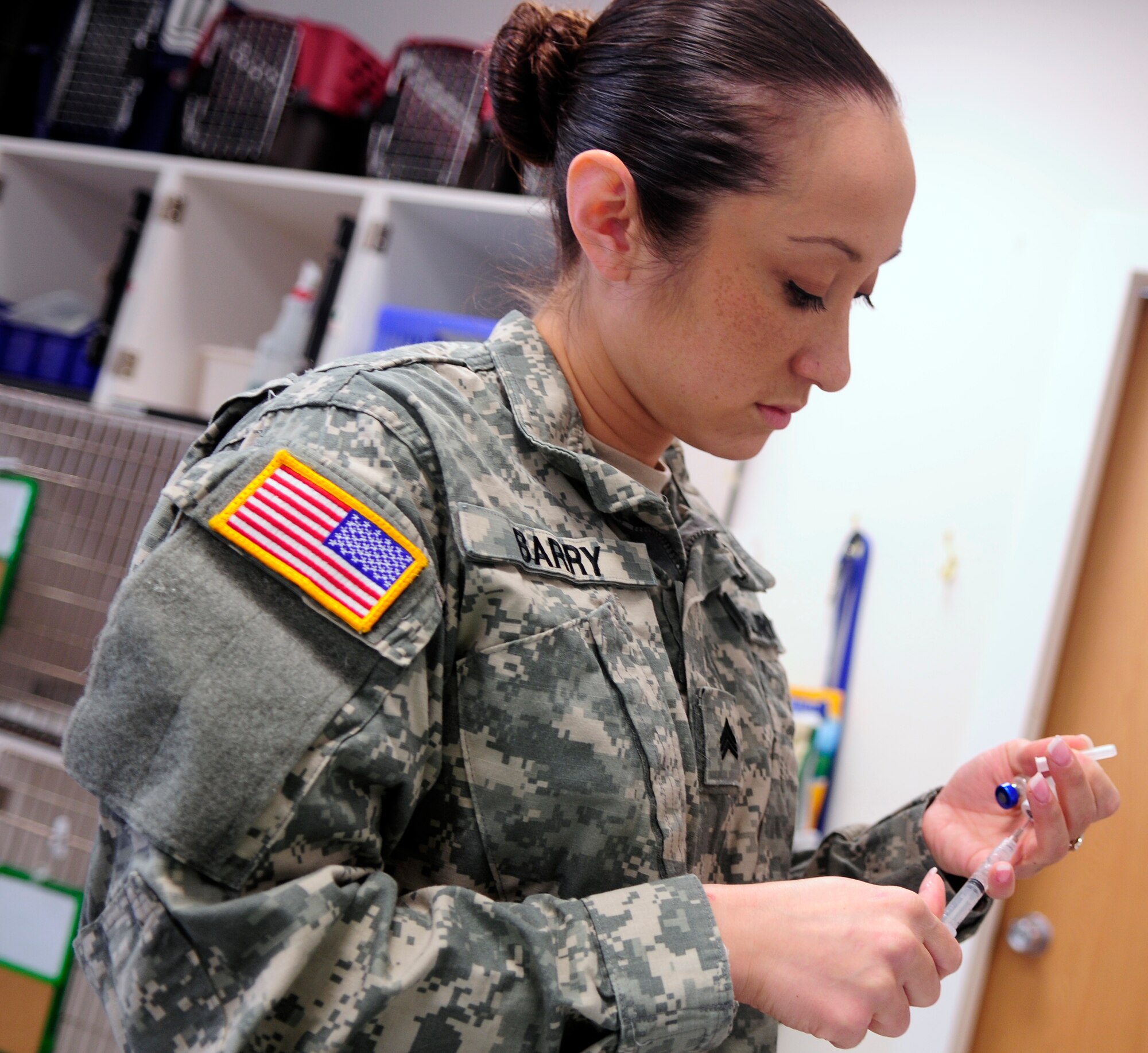 Army Sgt. Juliane Barry, Aviano veterinary treatment facility NCO in charge, prepares a vaccine March 30 at Aviano Air Base, Italy. Vaccines stimulate the immune system to produce antibodies and prevent diseases. Barry gives vaccine shots to more than 250 pets per month. (U.S. Air Force photo/Airman 1st Class Briana Jones)