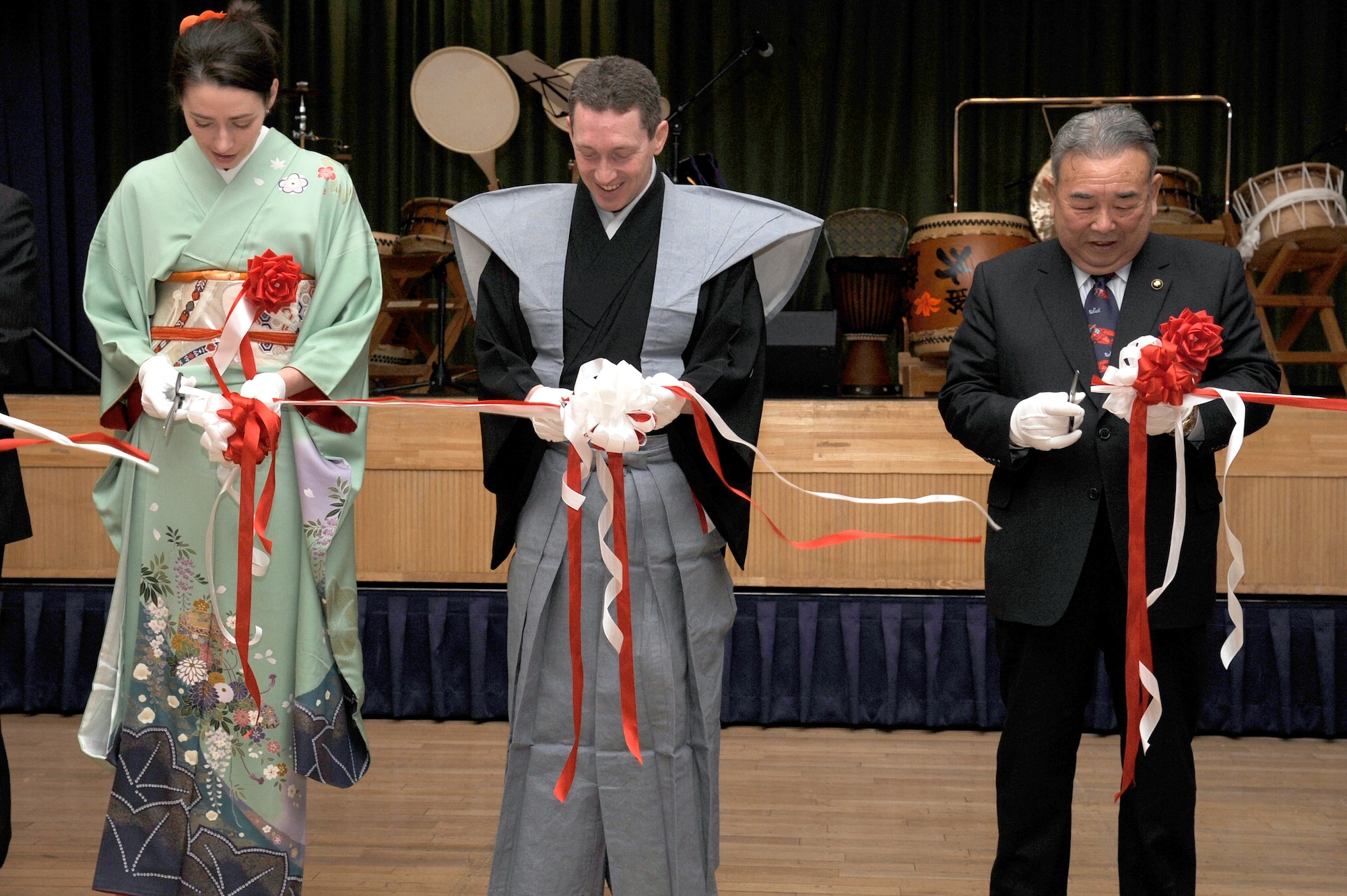 Jenn Rothstein, left, along with her husband U.S. Air Force Col. Michael D. Rothstein, 35th Fighter Wing commander, center, and the Honorable Kazumasa Taneichi, Misawa City mayor, cut the ribbon to kick off the 25th Annual Japan Day, at Misawa Air Base, Japan, April 7, 2012. More than 50 cultural displays, hands-on demonstrations, live music, and theatrical demonstrations were available for Misawa residents to enjoy. (U.S. Air Force photo by Tech. Sgt. Marie Brown/Released)
