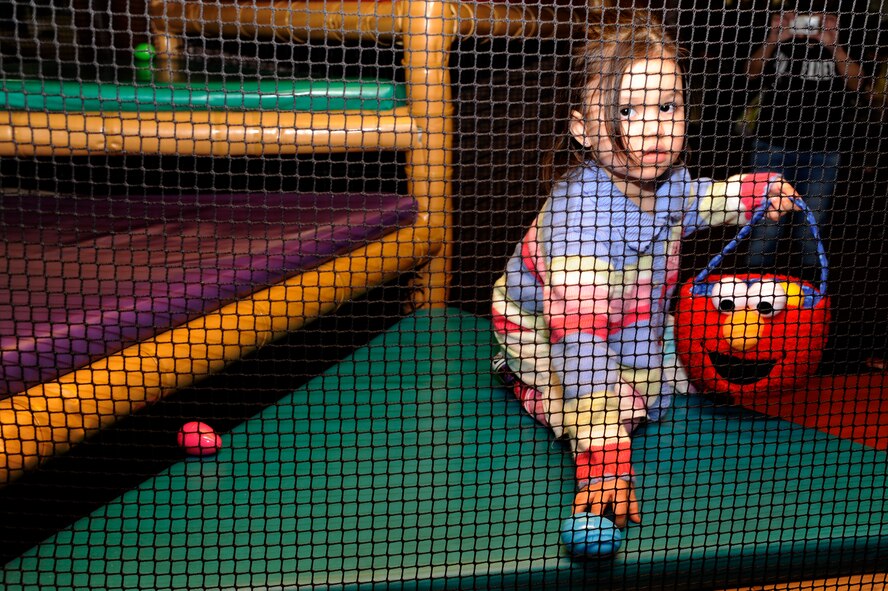 The daughter of U.S. Navy Chief Petty Officer Sean Righter, Aircraft Intermediate Maintenance Detachment, picks up a plastic egg during the 35th Force Support Squadron egg'stravaganza at Misawa Air Base, Japan, April 8, 2012. Children hunted for plastic eggs full of goodies donated by the Exchange and base Commissary. (U.S. Air Force photo by Tech. Sgt. Marie Brown/Released)
