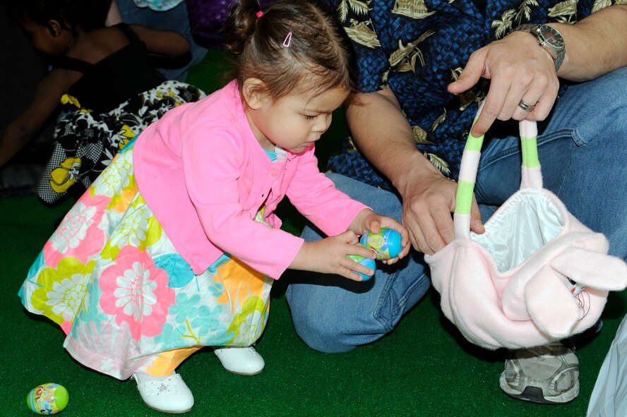 The daughter of U.S. Air Force Tech. Sgt. Marie Brown, 35th Fighter Wing public affairs, collects eggs filled with candy and stickers during the 35th Force Support Squadron egg'stravaganza at Misawa Air Base, Japan, April 8, 2012. The event was sponsored by 35 FSS, the Exchange and the base Commissary and included a visit by the Easter Bunny. (U.S. Air Force photo by Tech. Sgt. Marie Brown/Released)
