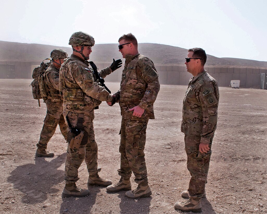 U.S. Army Lt. Col. Mark Dotson, right, greets U.S. Army Col. Mark L. Stock, left, on Forward Operating Base Warrior in Afghanistan's Ghazni province, April 1, 2012. Stock is the commander of the 82nd Airborne Division’s 1st Brigade Combat Team, and Dotson is the commander of the 3rd Squadron, 73rd Cavalry Regiment.