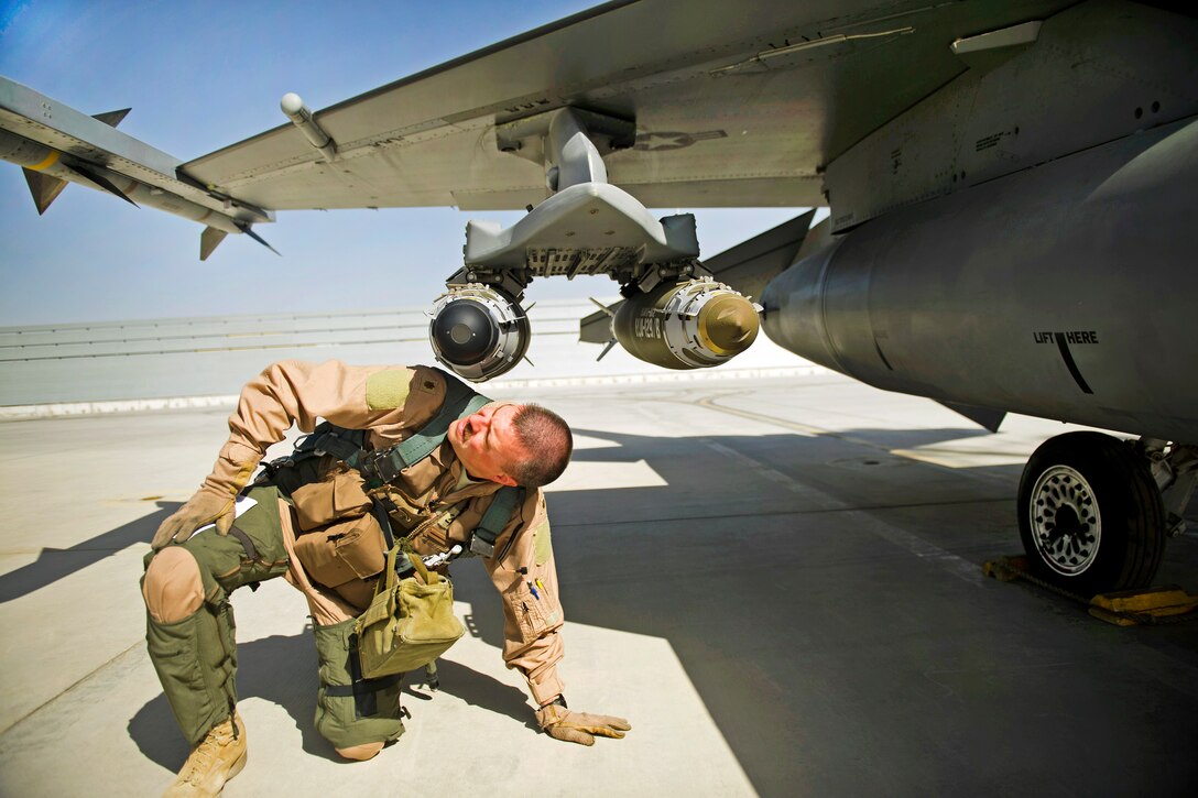 U.S. Air Force Maj. Todd Pierce inspects the bombs and missiles on an F-16C Fighting Falcon on Kandahar Airfield, Afghanistan, April 5, 2012. Pierce is a F-16C pilot assigned to the 451st Expeditionary Fighter Squadron.